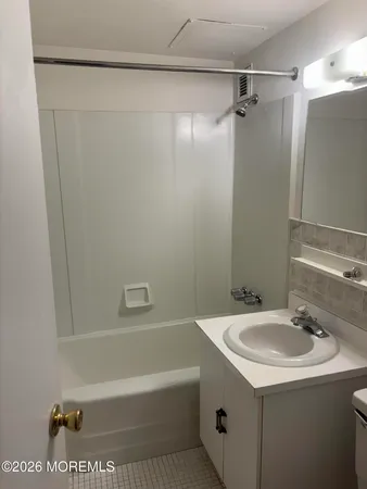 a bathroom with a sink a mirror and a bathtub
