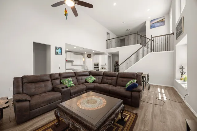 a living room with furniture and wooden floor