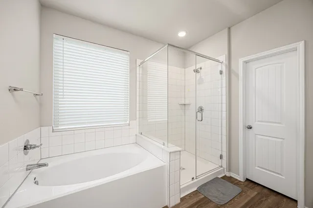 a bathroom with a bathtub and a shower