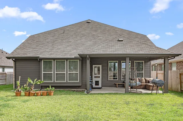 a view of a house with a yard and sitting area