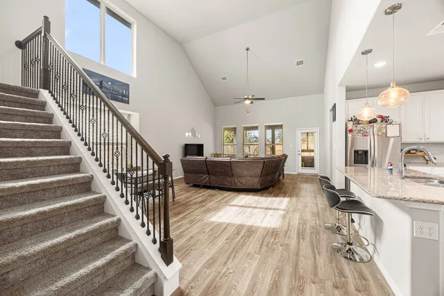 a view of staircase and living room with wooden floor