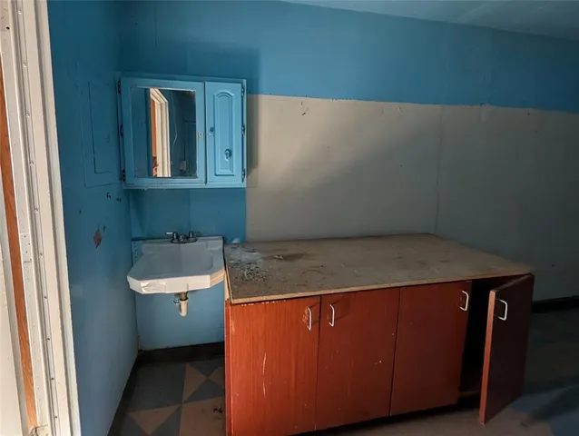 a bathroom with a sink and mirror