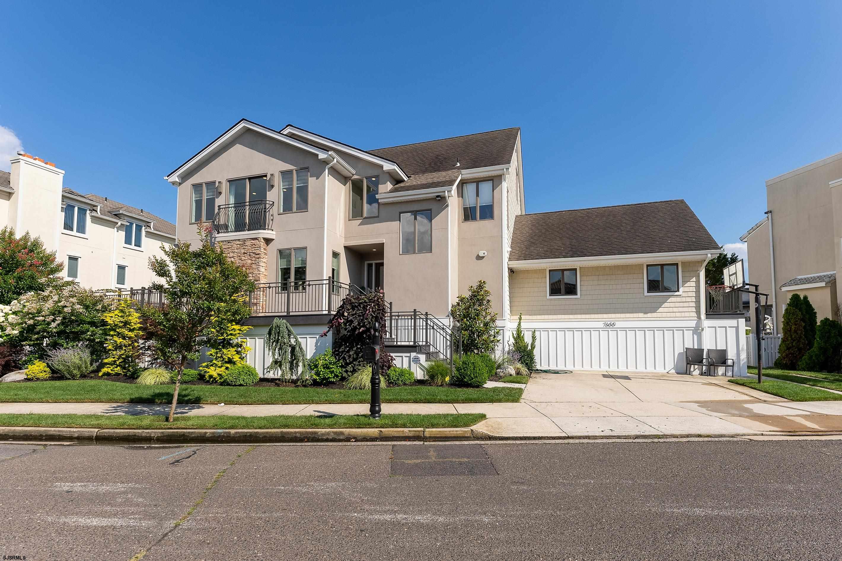 7600 Bayshore Drive, Unit SEPTEMBER 2026 Margate City, NJ 08402 - Photo 1 of 55 a front view of a house with a yard and garage
