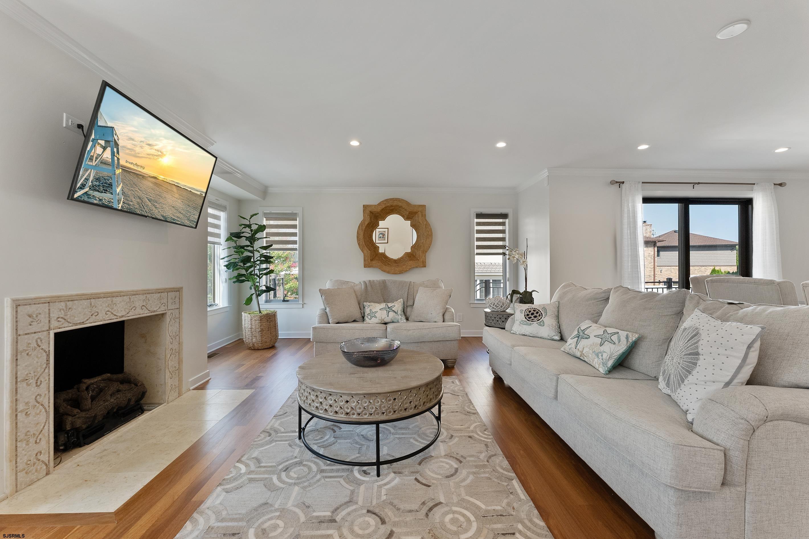 7600 Bayshore Drive, Unit SEPTEMBER 2026 Margate City, NJ 08402 - Photo 11 of 55 a living room with furniture and a fireplace