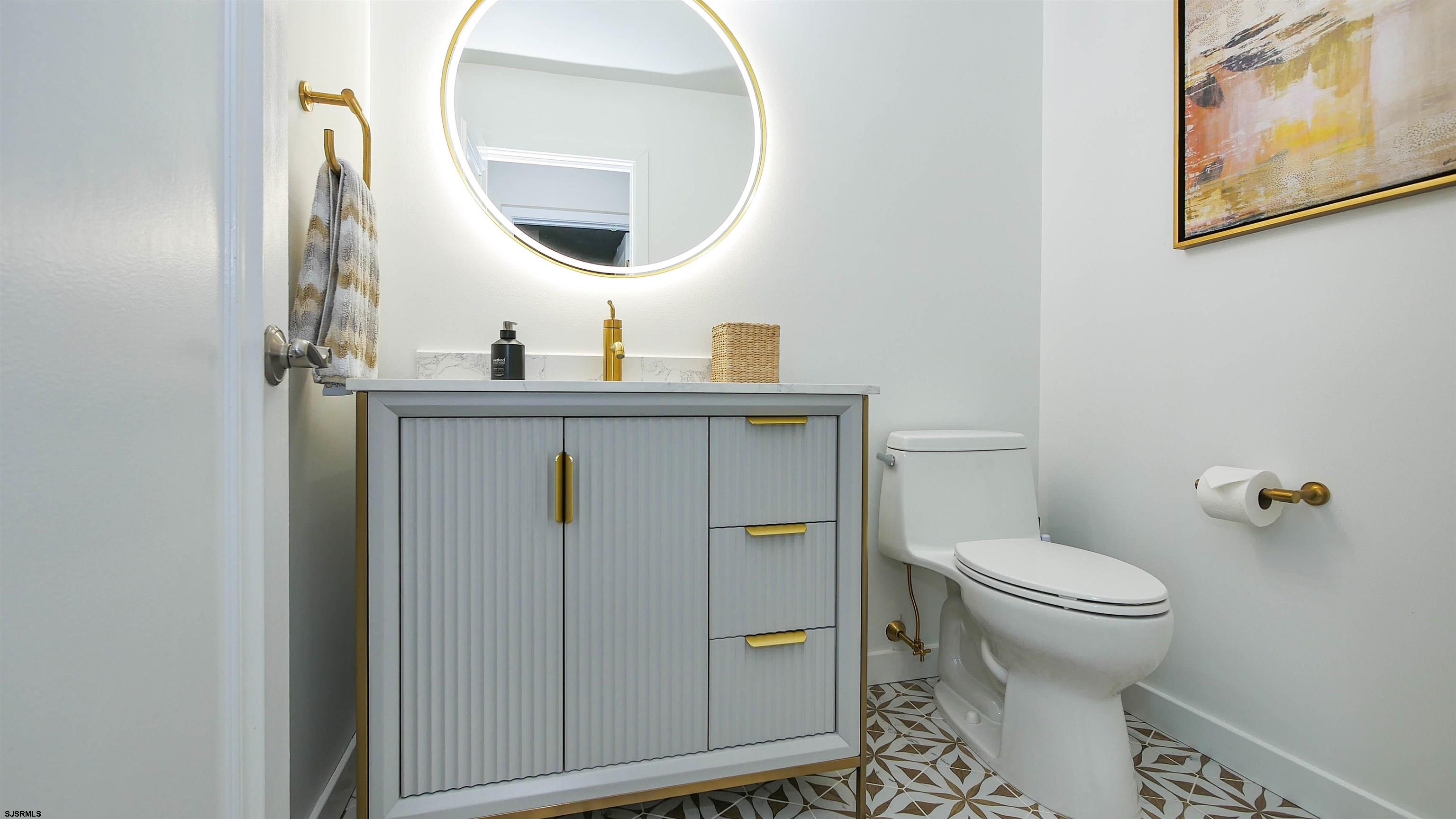 7600 Bayshore Drive, Unit SEPTEMBER 2026 Margate City, NJ 08402 - Photo 19 of 55 a bathroom with a toilet a sink and mirror