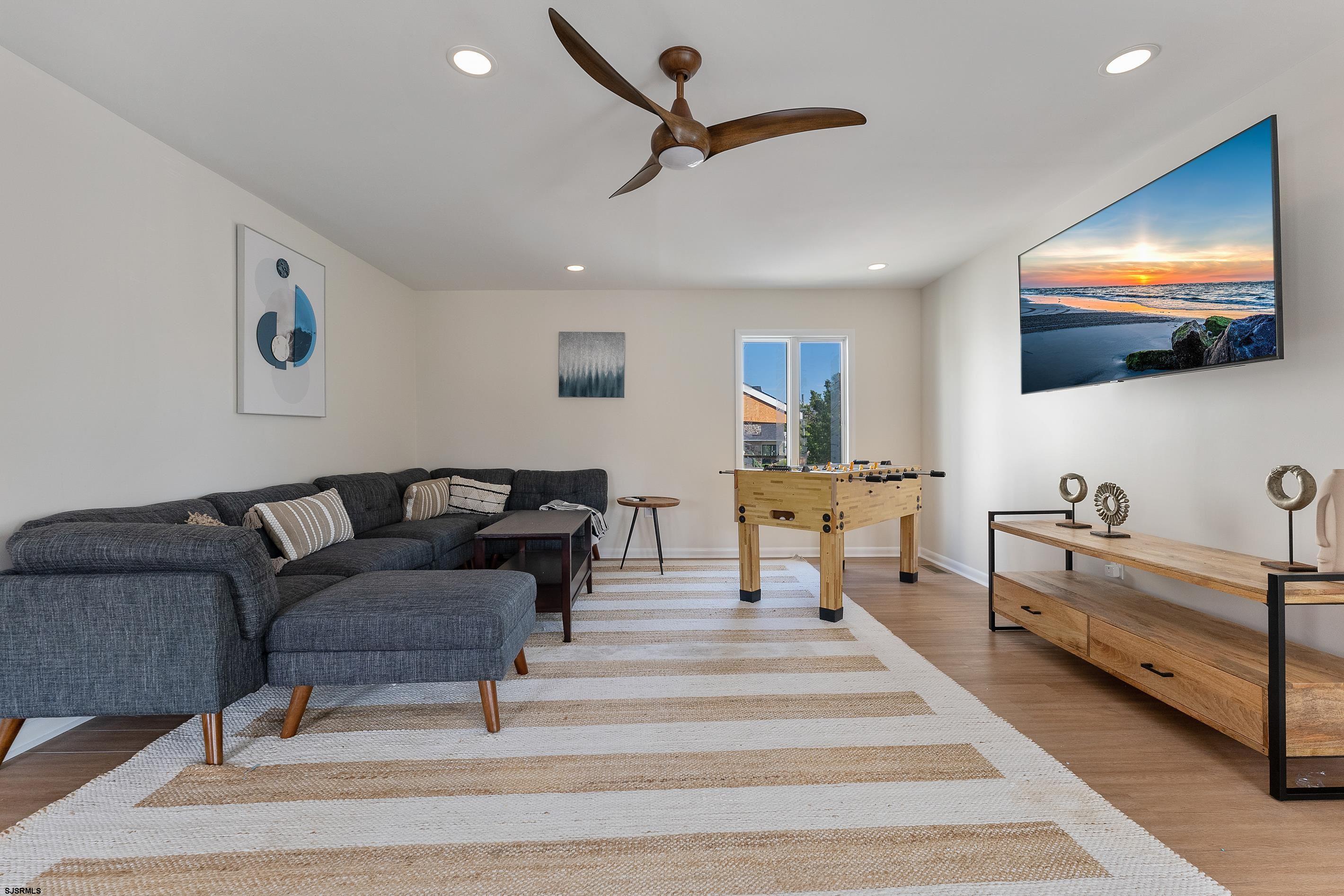 7600 Bayshore Drive, Unit SEPTEMBER 2026 Margate City, NJ 08402 - Photo 20 of 55 a living room with furniture and a flat screen tv