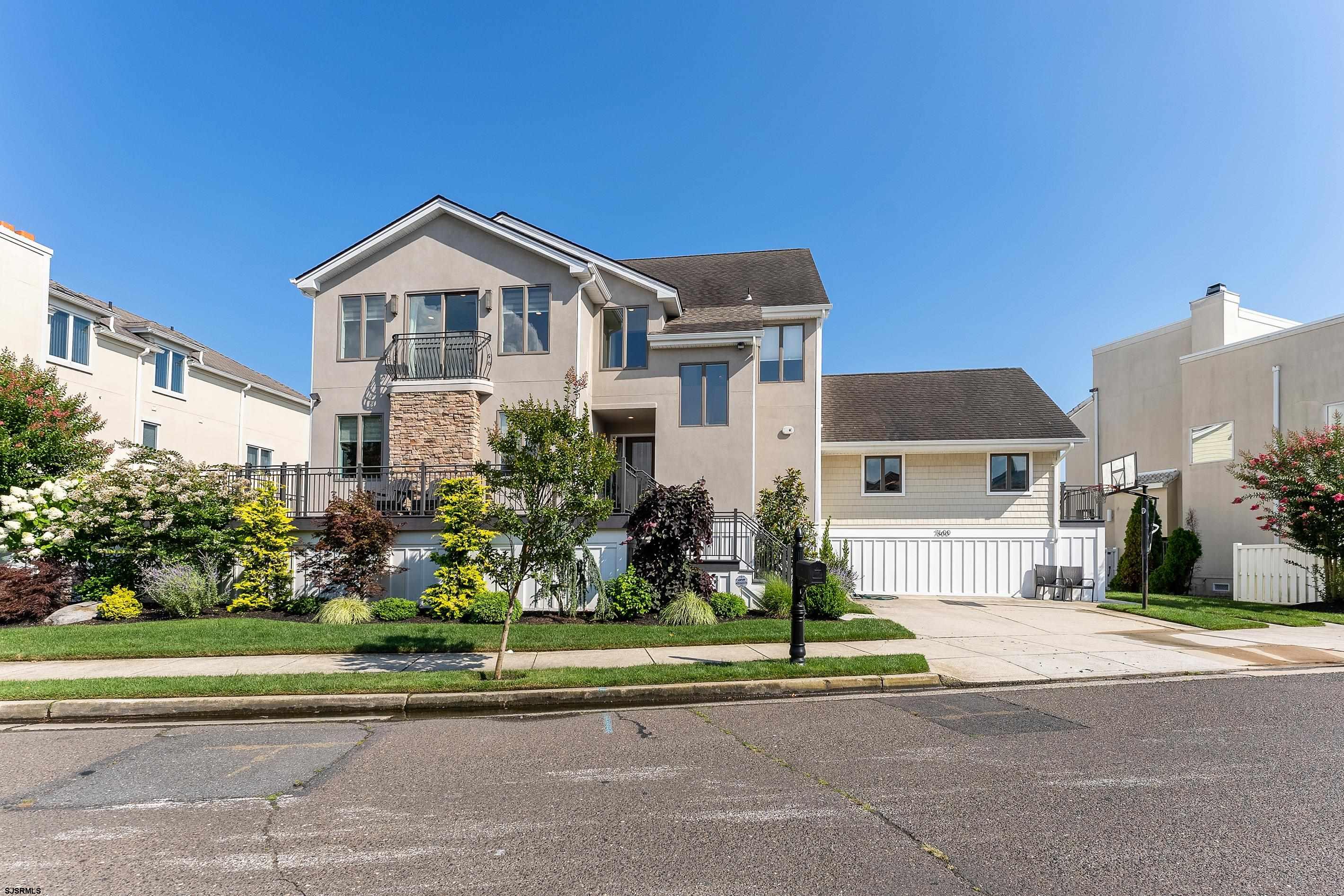 7600 Bayshore Drive, Unit SEPTEMBER 2026 Margate City, NJ 08402 - Photo 2 of 55 a front view of a house with a yard