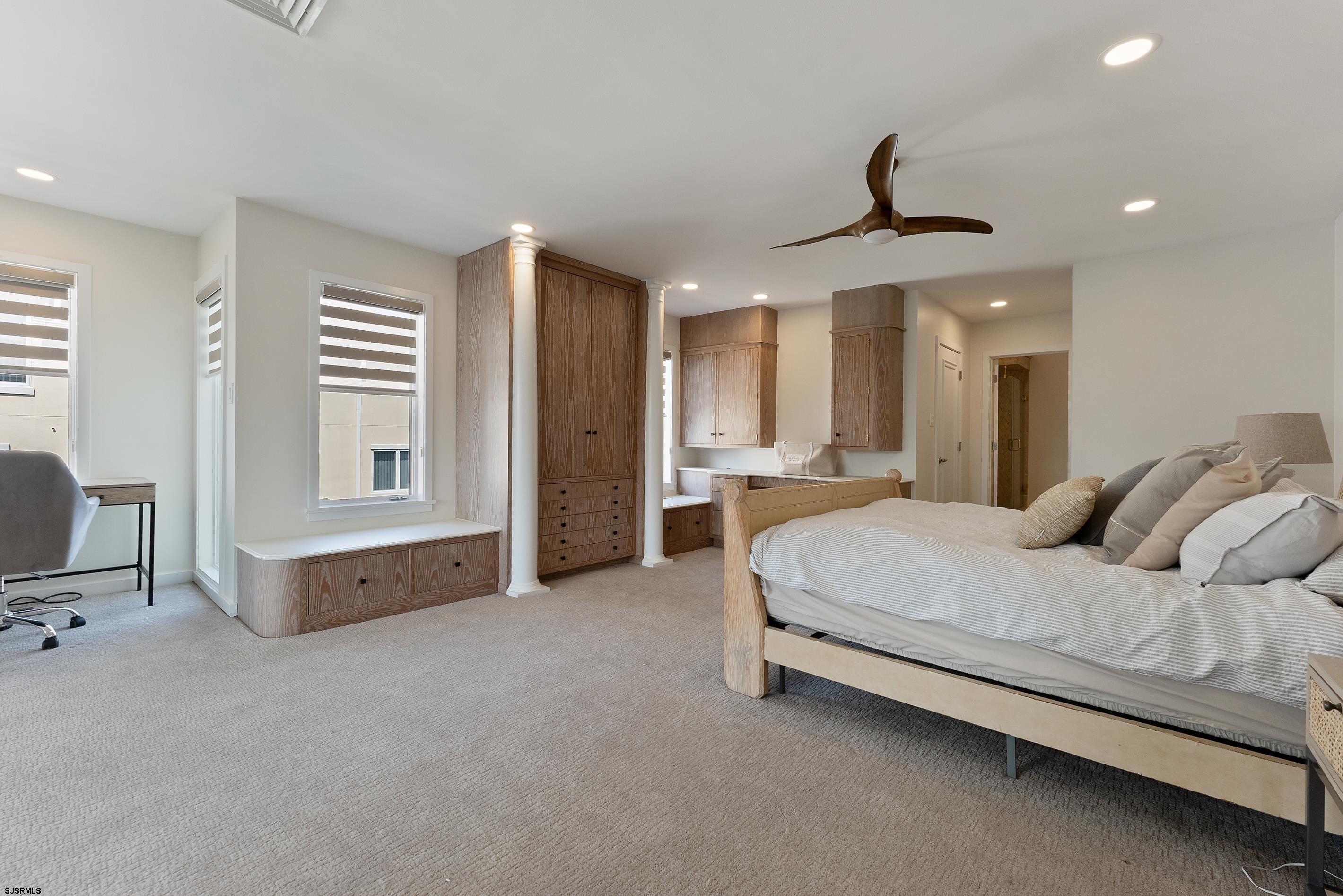 7600 Bayshore Drive, Unit SEPTEMBER 2026 Margate City, NJ 08402 - Photo 27 of 55 a spacious bedroom with a bed and ceiling fan