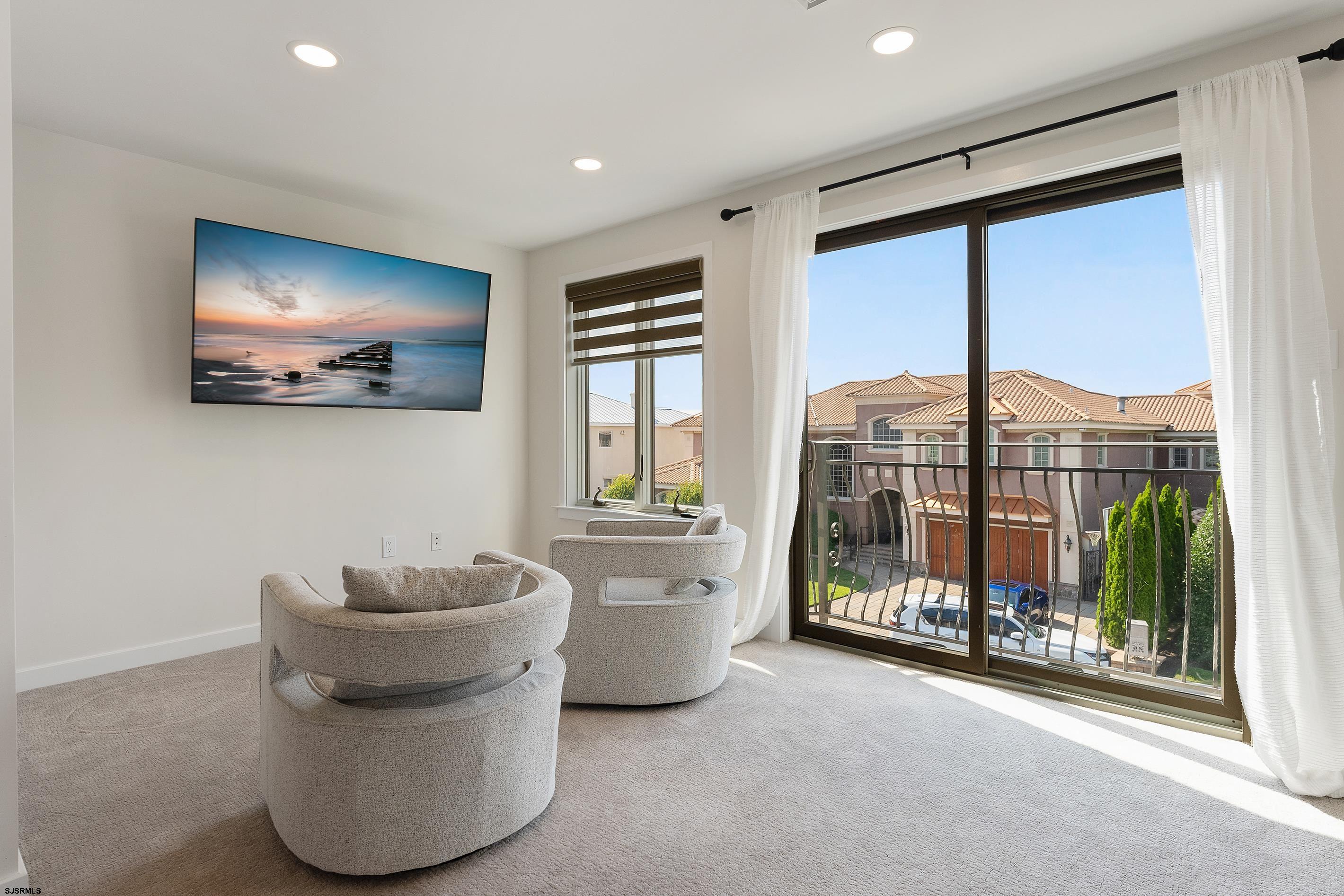 7600 Bayshore Drive, Unit SEPTEMBER 2026 Margate City, NJ 08402 - Photo 28 of 55 a living room with furniture and a flat screen tv