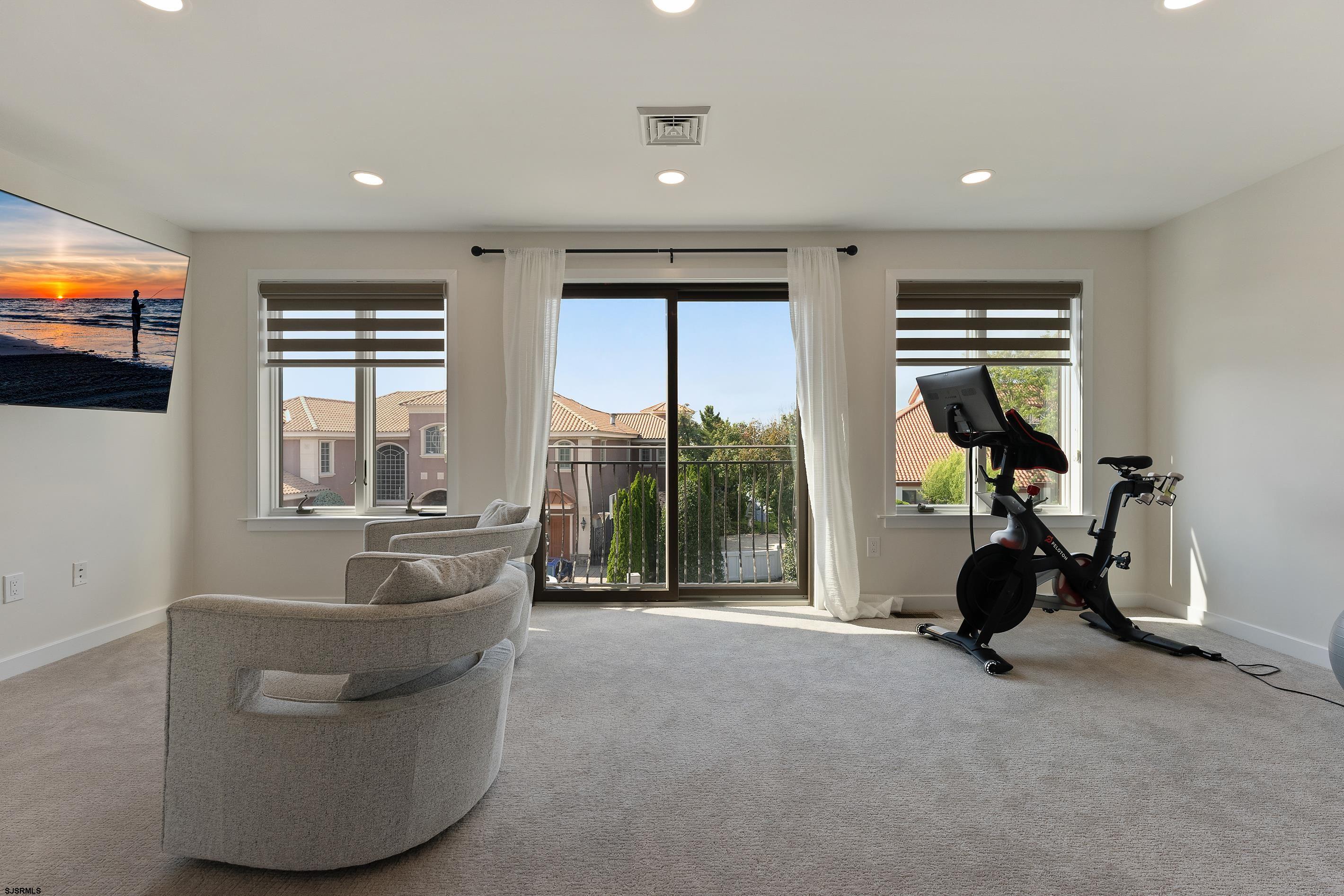 7600 Bayshore Drive, Unit SEPTEMBER 2026 Margate City, NJ 08402 - Photo 29 of 55 a living room with furniture and a flat screen tv