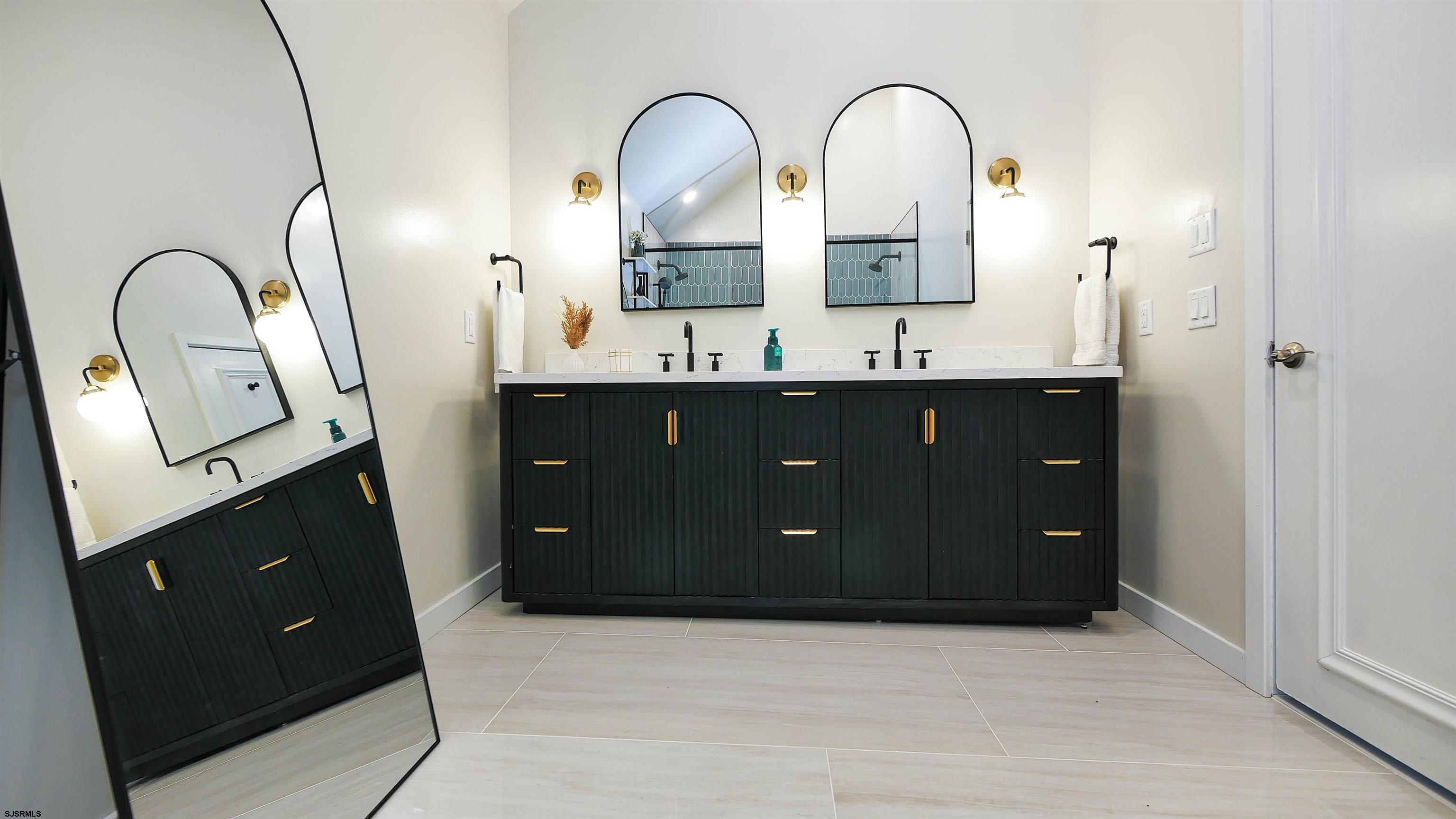 7600 Bayshore Drive, Unit SEPTEMBER 2026 Margate City, NJ 08402 - Photo 31 of 55 a bathroom with a double vanity sink and mirror