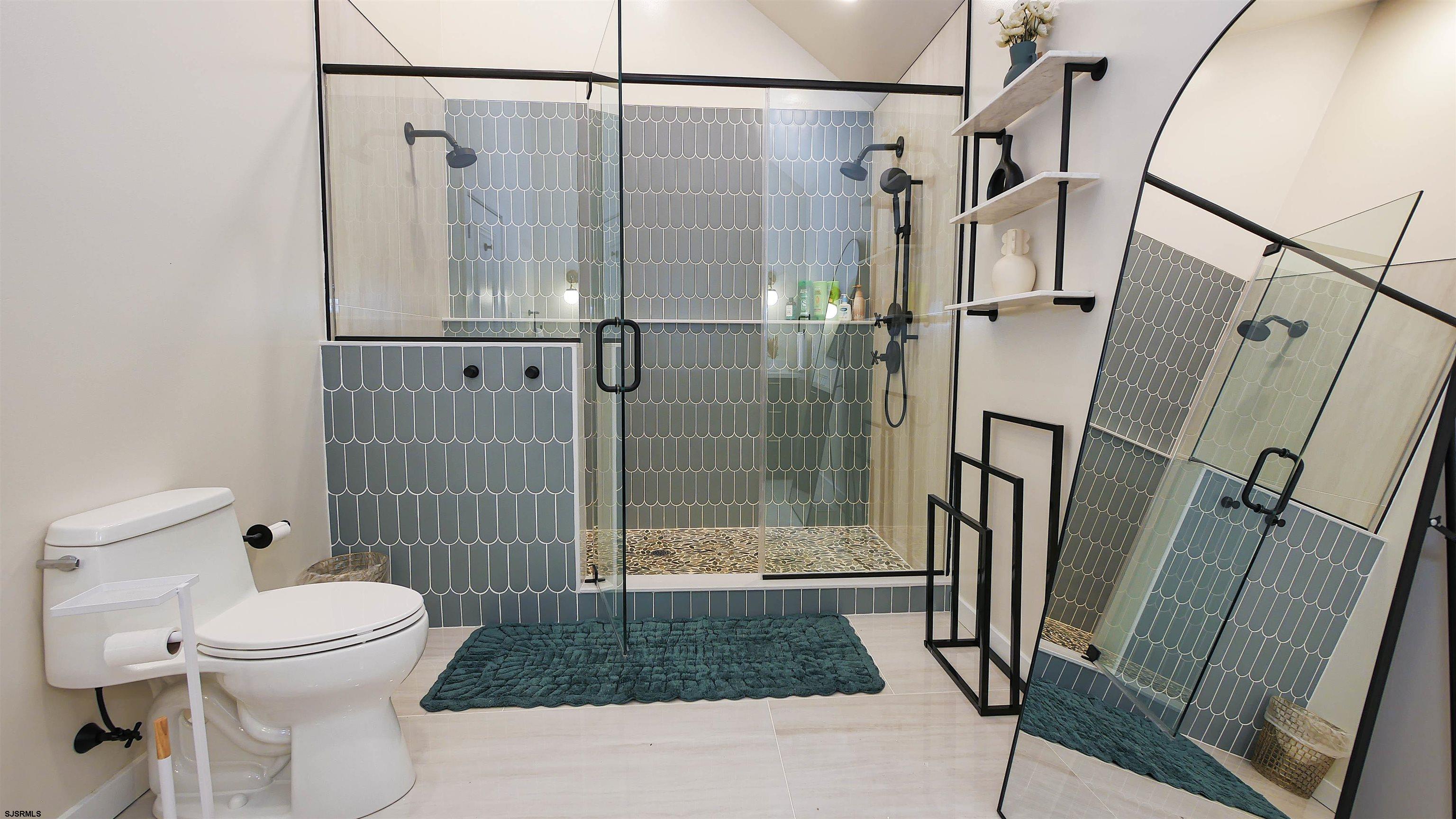 7600 Bayshore Drive, Unit SEPTEMBER 2026 Margate City, NJ 08402 - Photo 32 of 55 a bathroom with a shower toilet and sink