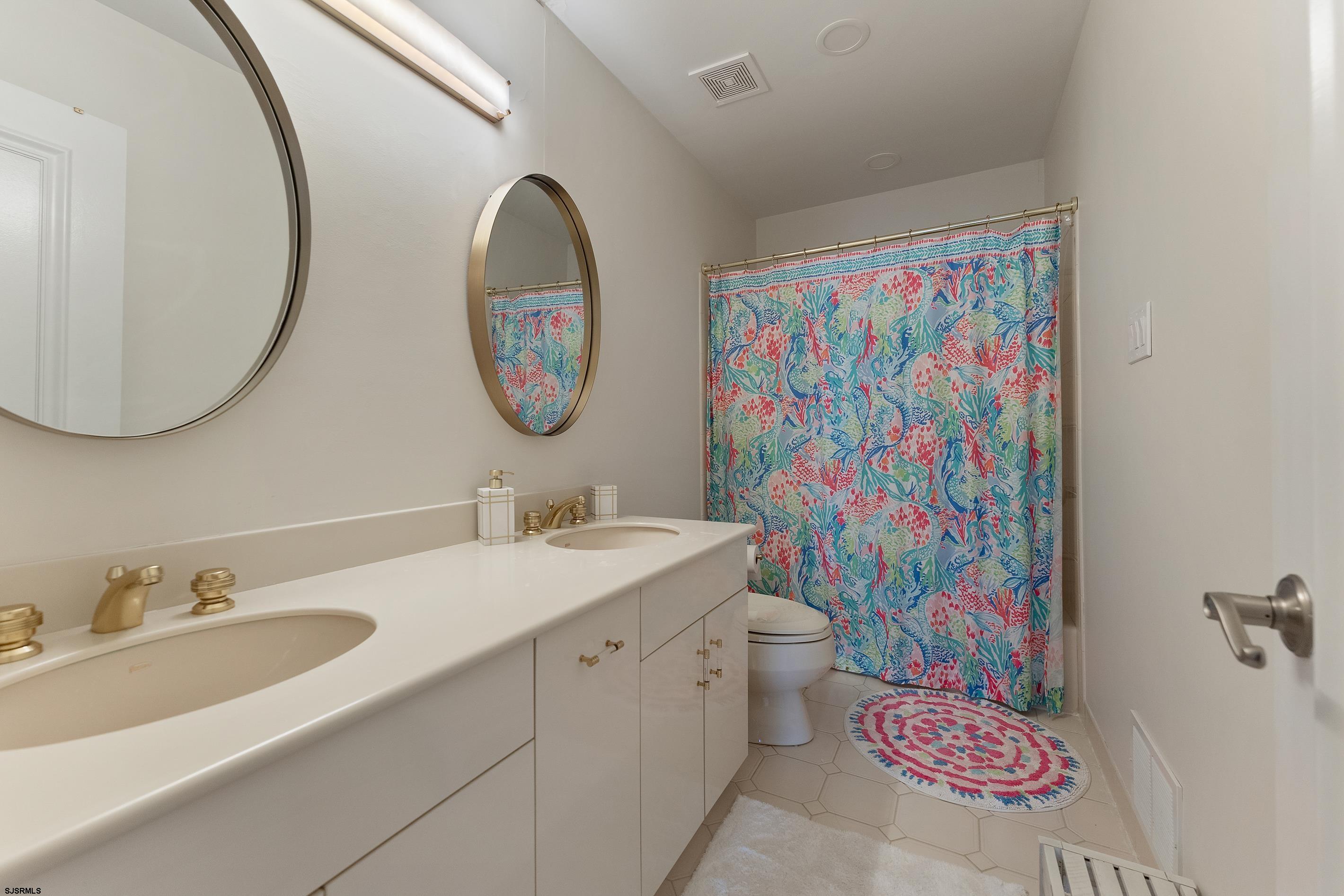 7600 Bayshore Drive, Unit SEPTEMBER 2026 Margate City, NJ 08402 - Photo 36 of 55 a bathroom with a sink a vanity and a mirror