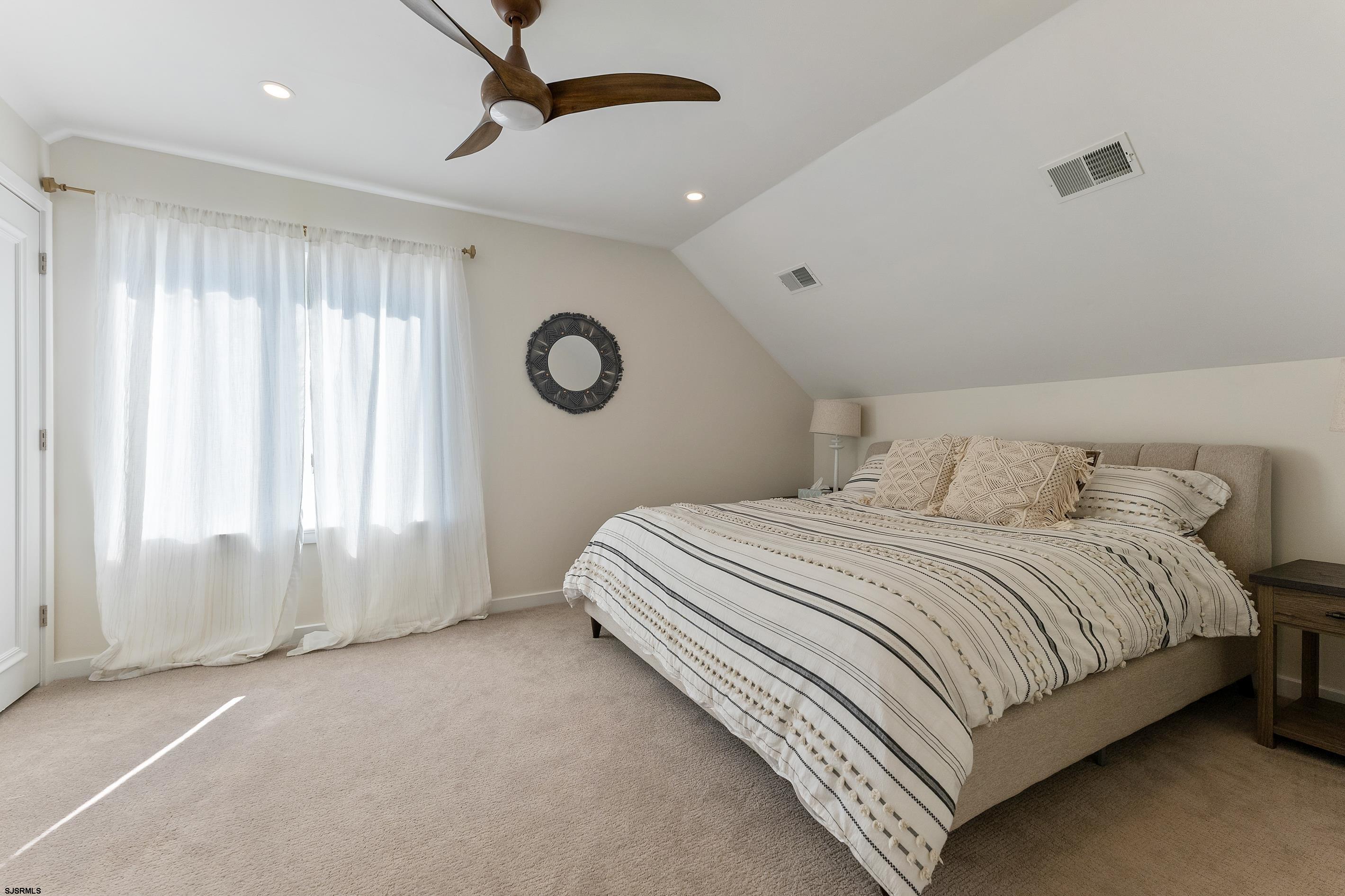 7600 Bayshore Drive, Unit SEPTEMBER 2026 Margate City, NJ 08402 - Photo 38 of 55 a bedroom with a bed and a window