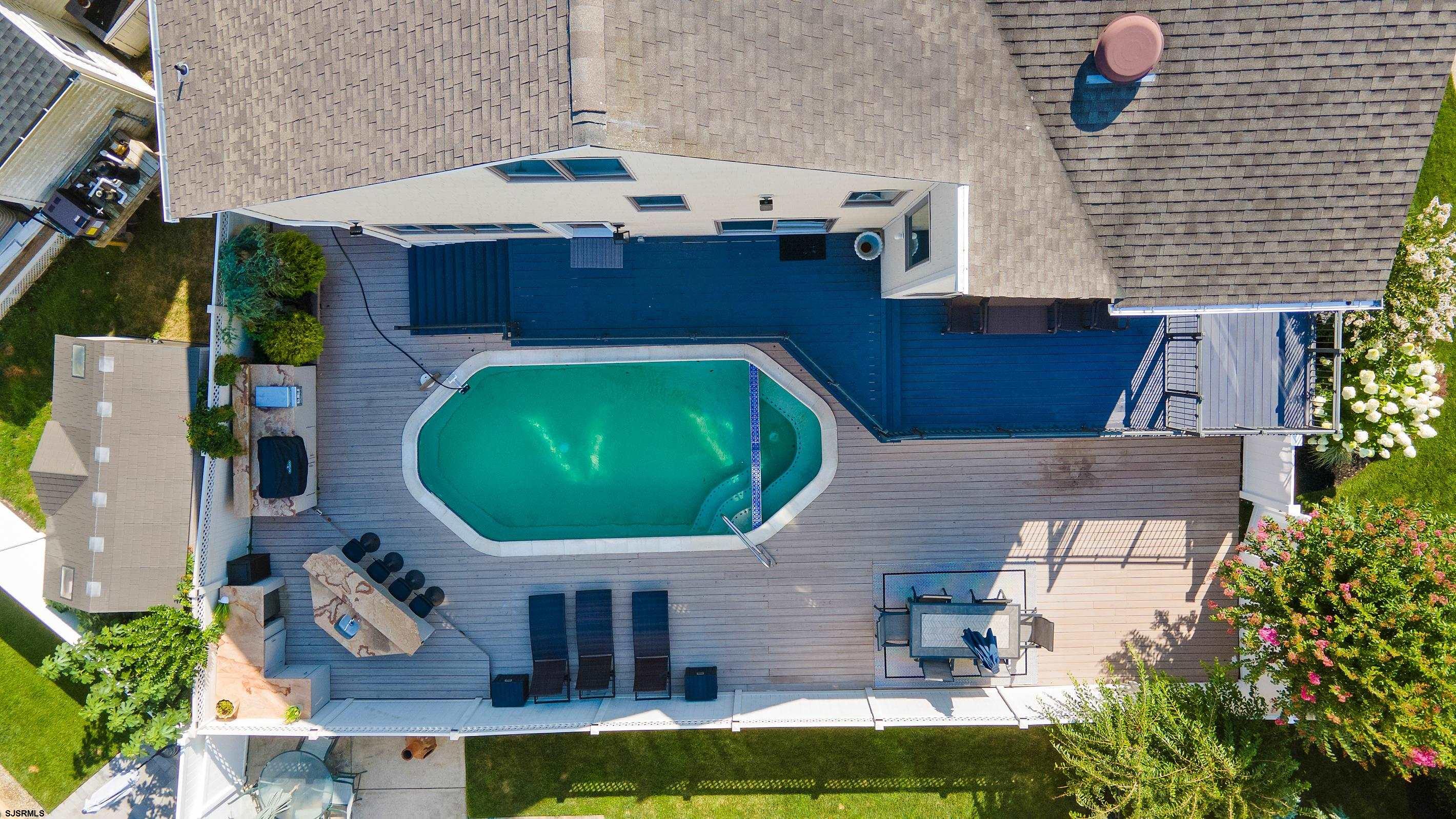 7600 Bayshore Drive, Unit SEPTEMBER 2026 Margate City, NJ 08402 - Photo 4 of 55 an aerial view of a house with swimming pool patio and outdoor seating