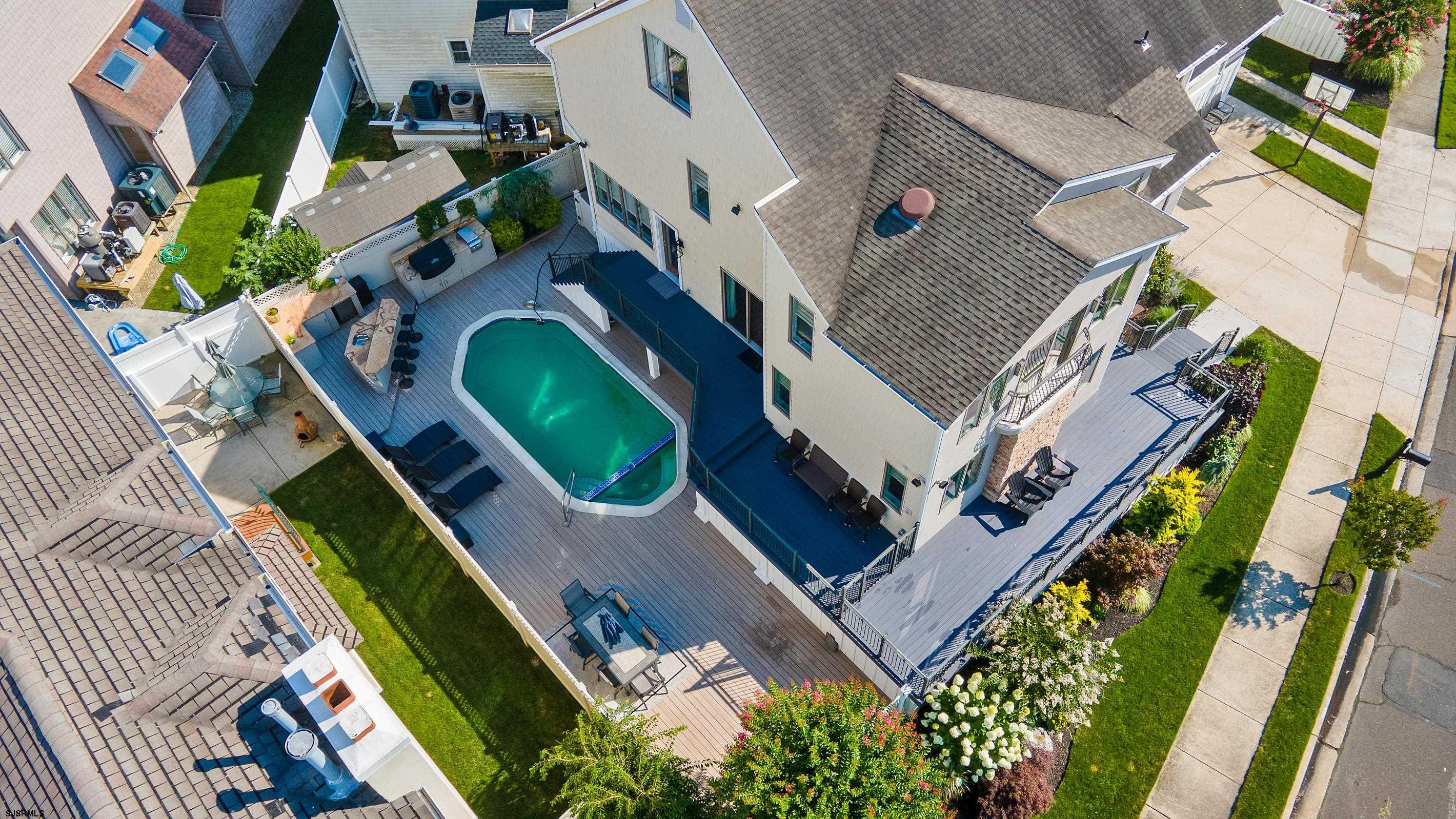 7600 Bayshore Drive, Unit SEPTEMBER 2026 Margate City, NJ 08402 - Photo 48 of 55 an aerial view of a house with a swimming pool