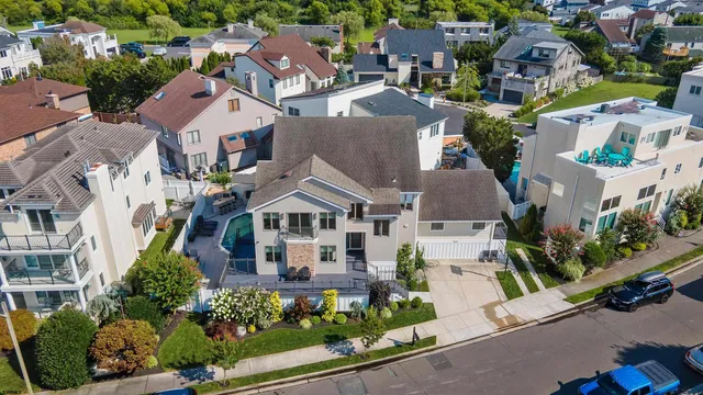 an aerial view of multiple houses with yard