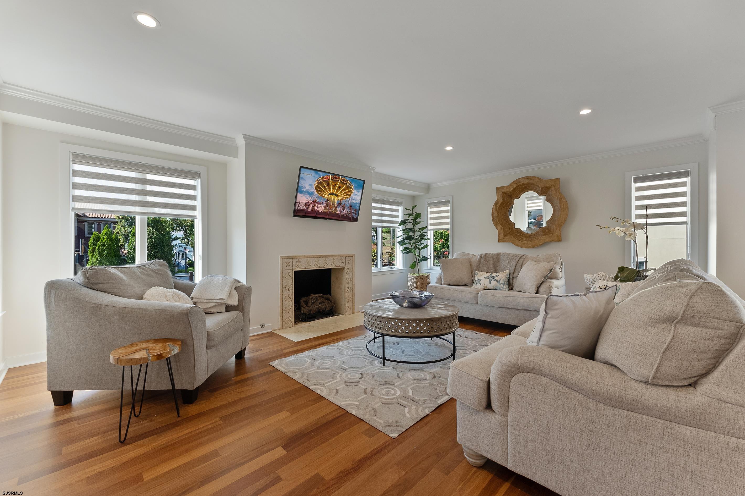 7600 Bayshore Drive, Unit SEPTEMBER 2026 Margate City, NJ 08402 - Photo 8 of 55 a living room with furniture a fireplace and a large window
