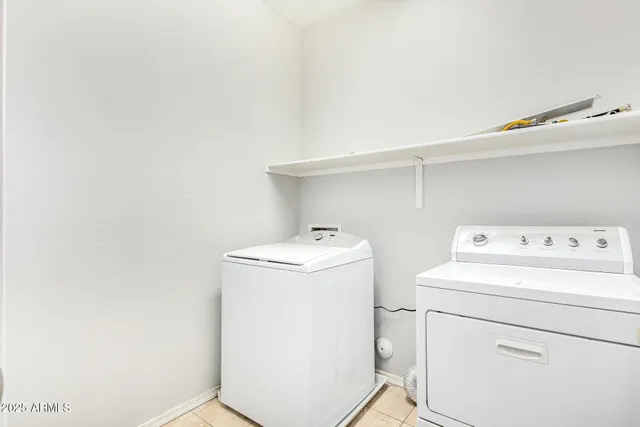 a backyard of a house with barbeque oven table and chairs