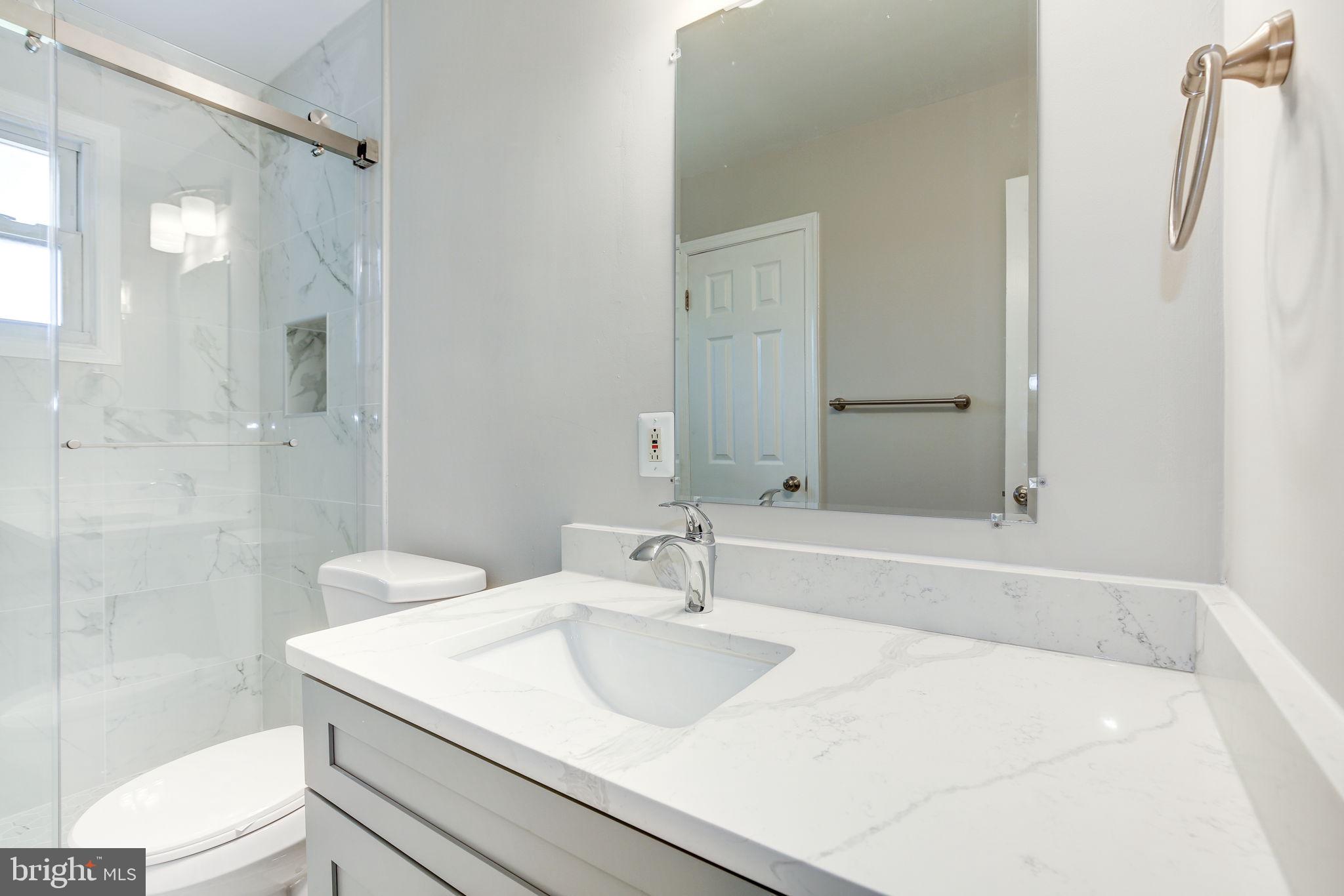 11830 Charles Road Silver Spring, MD 20906 - Photo 13 of 54 a bathroom with a sink a shower and a mirror