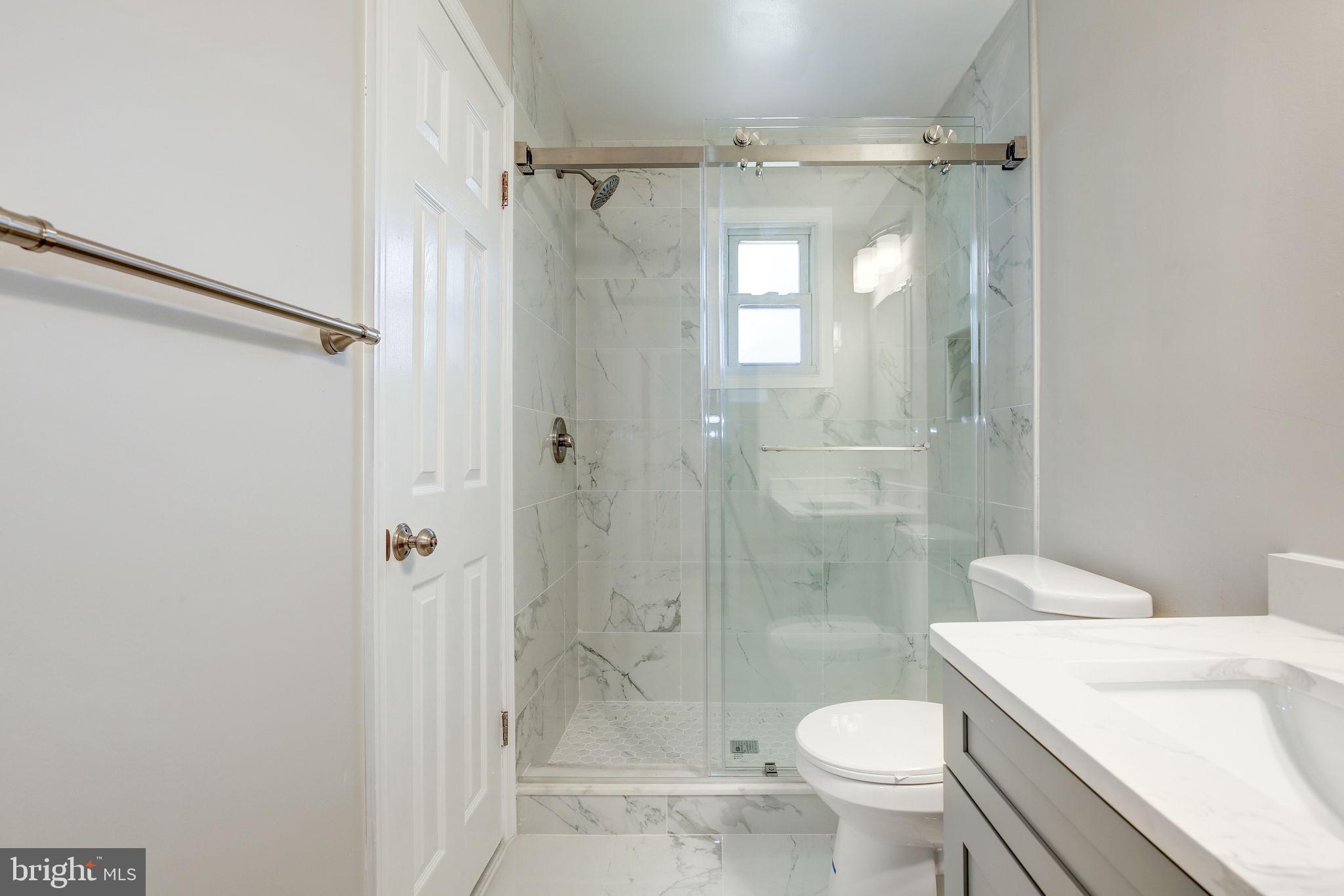 11830 Charles Road Silver Spring, MD 20906 - Photo 14 of 54 a bathroom with a granite countertop toilet a shower and a sink