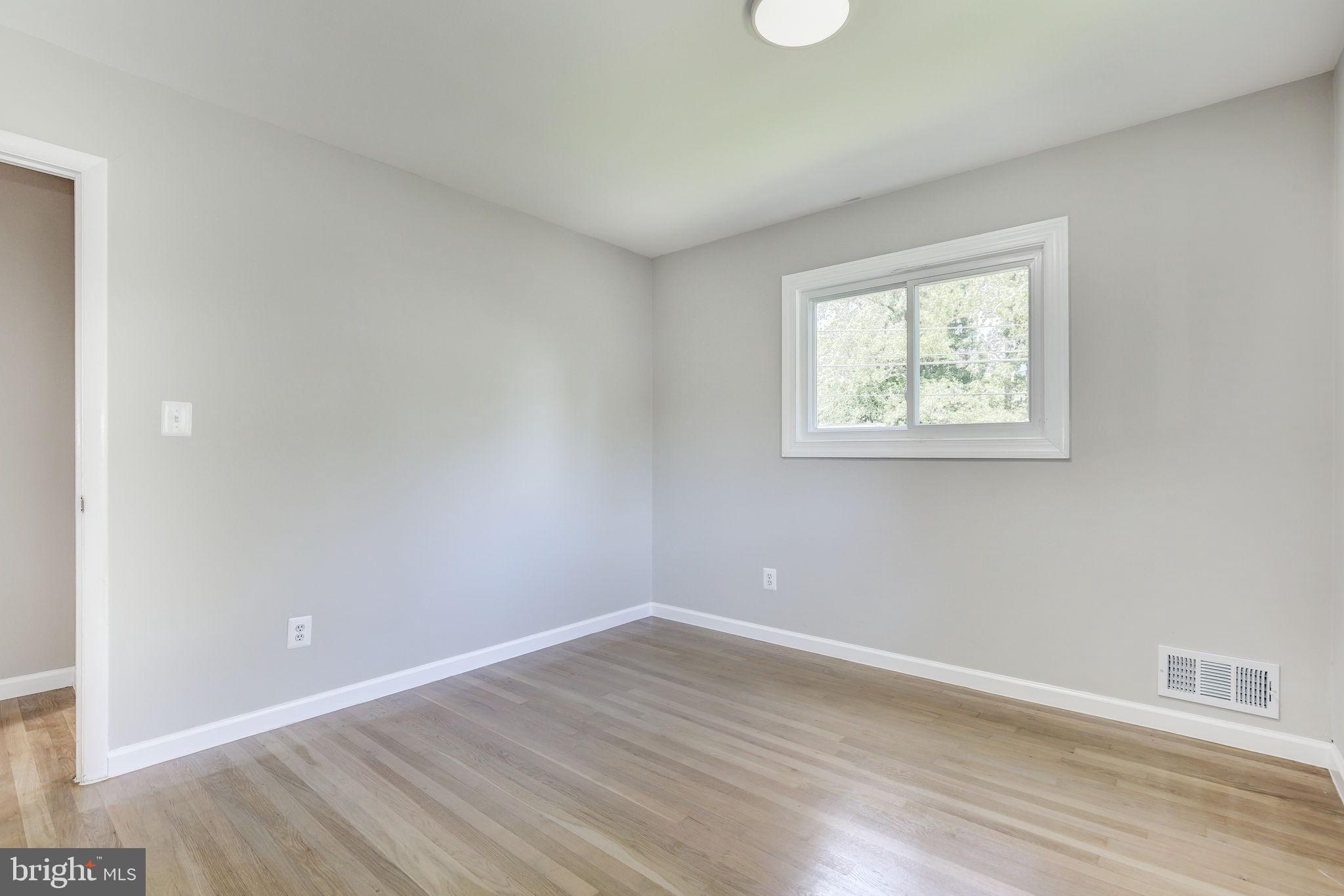 11830 Charles Road Silver Spring, MD 20906 - Photo 21 of 54 wooden floor in an empty room with a window