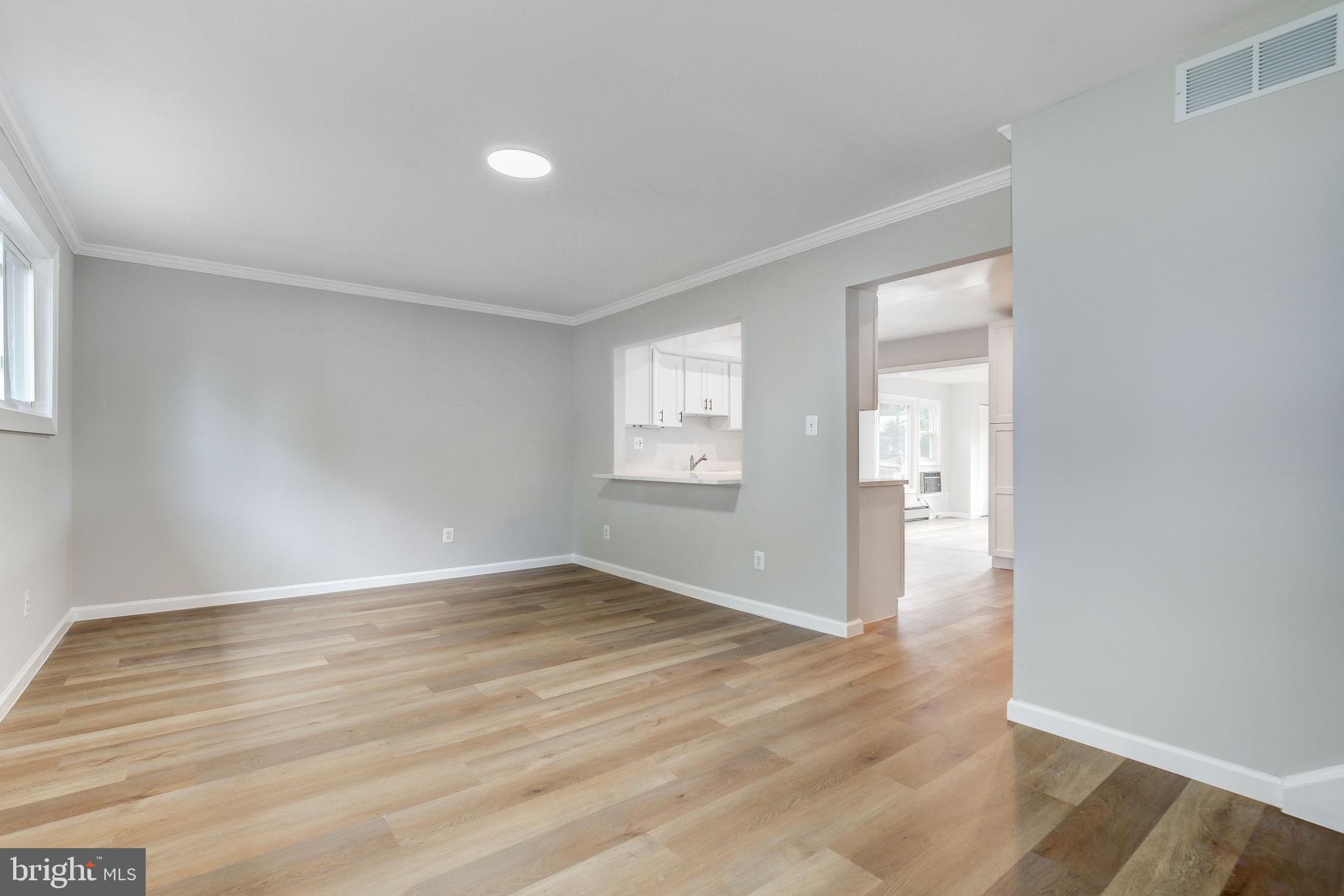 11830 Charles Road Silver Spring, MD 20906 - Photo 27 of 54 an empty room with wooden floor and windows