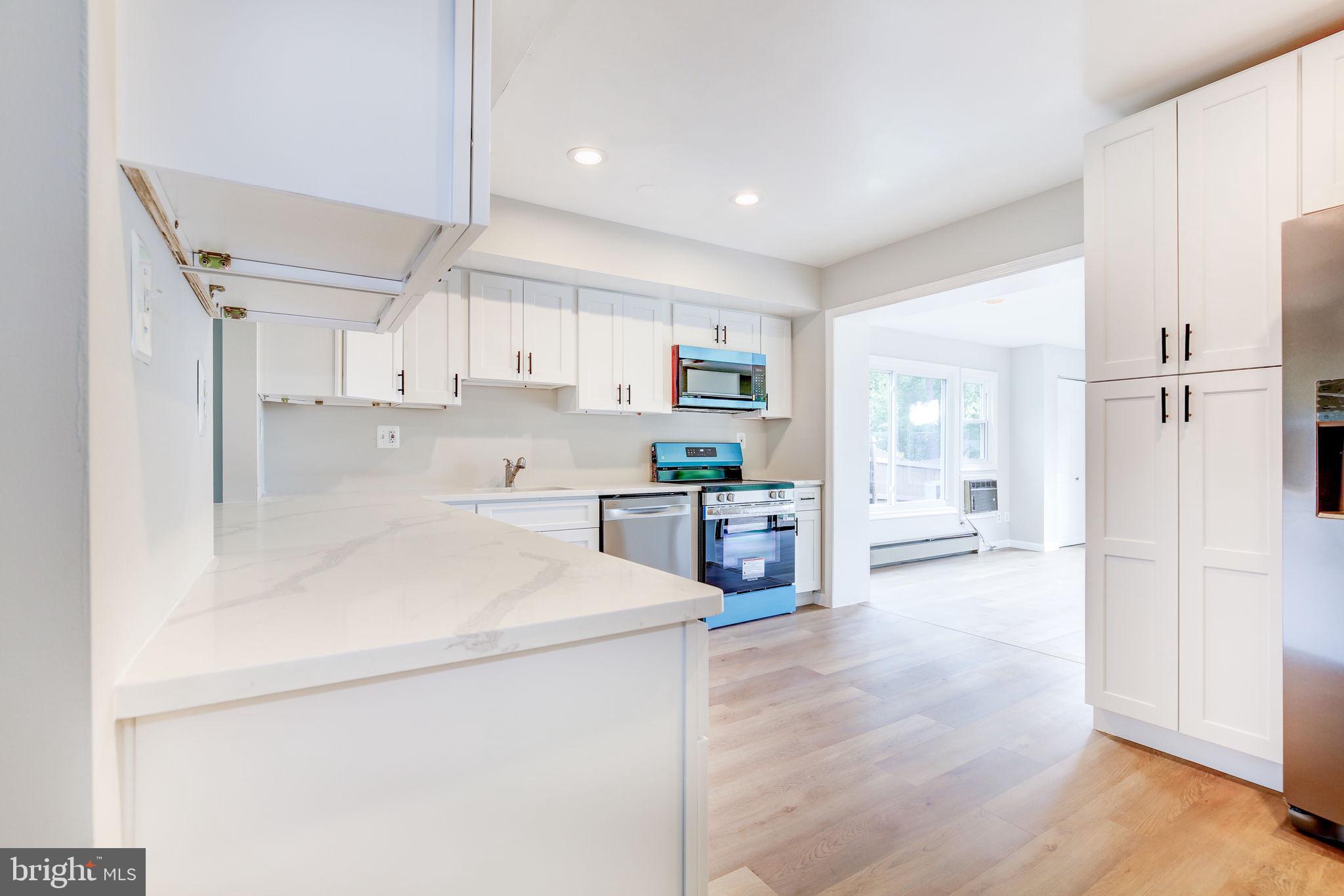 11830 Charles Road Silver Spring, MD 20906 - Photo 33 of 54 a kitchen with stainless steel appliances a refrigerator sink and cabinets