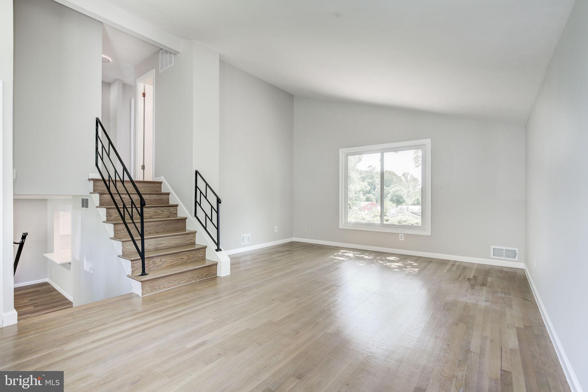 11830 Charles Road Silver Spring, MD 20906 - Photo 4 of 54 a view of an empty room with wooden floor and a window