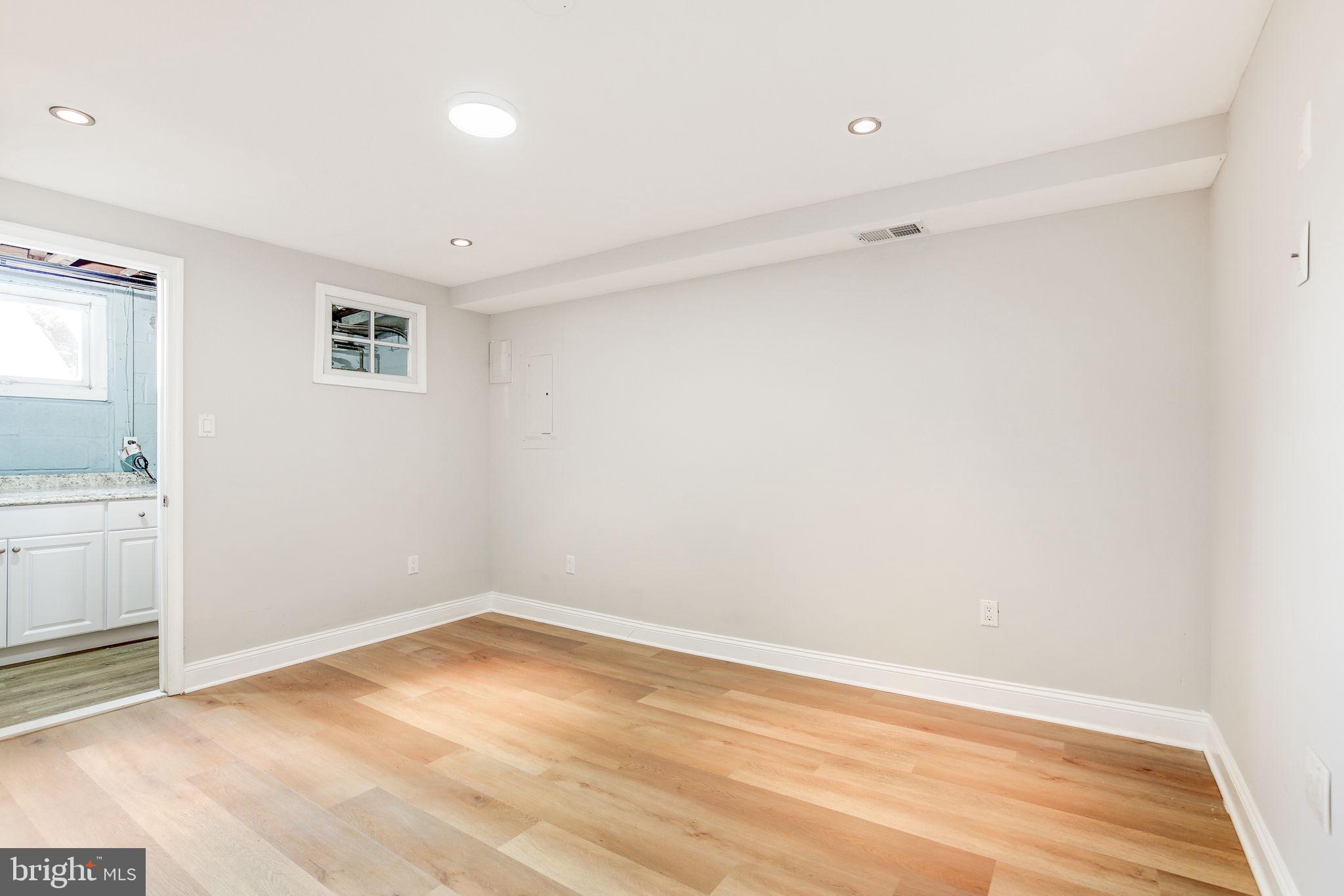 11830 Charles Road Silver Spring, MD 20906 - Photo 43 of 54 a view of a room with wooden floor and white walls