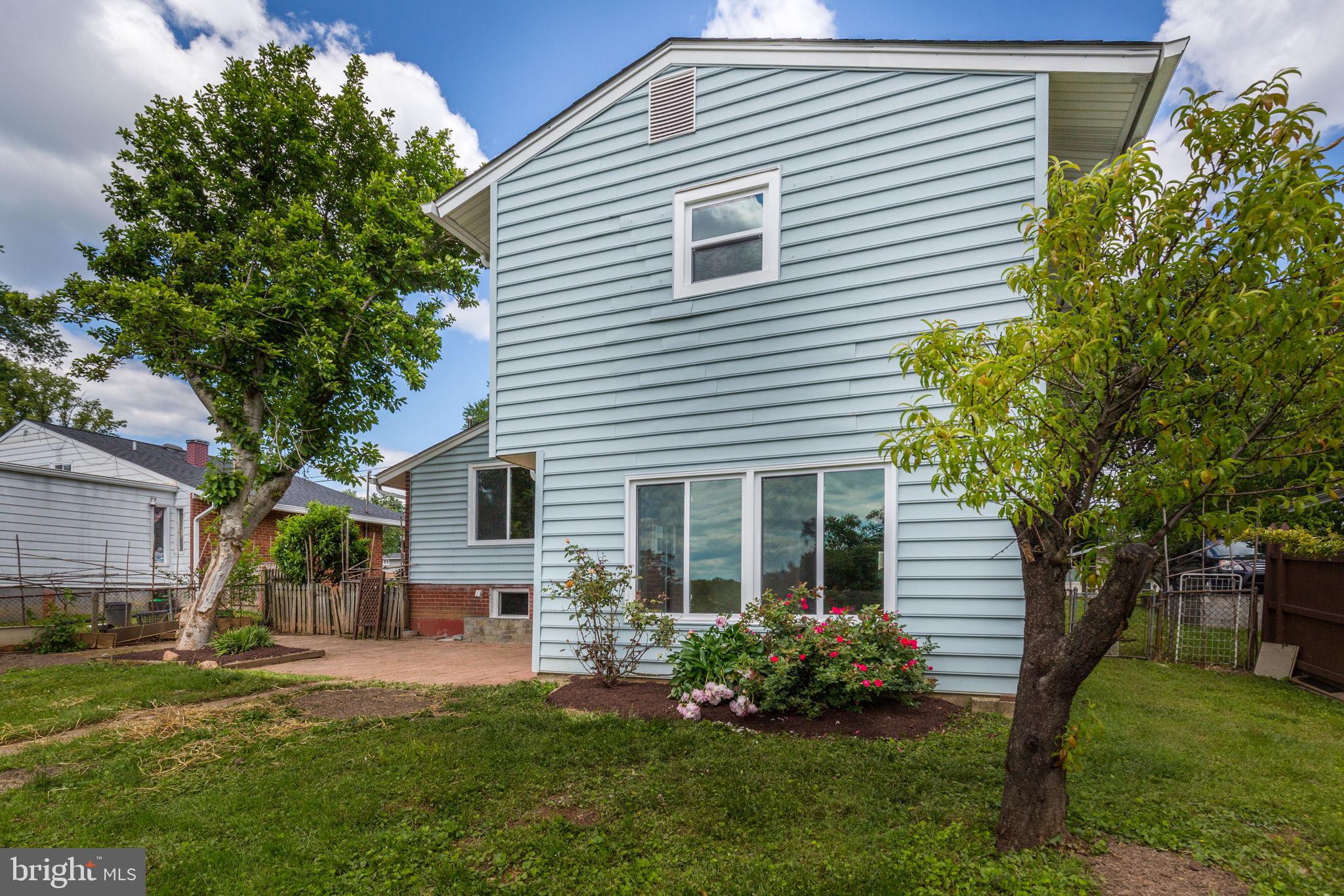 11830 Charles Road Silver Spring, MD 20906 - Photo 45 of 54 a front view of a house with a garden and plants
