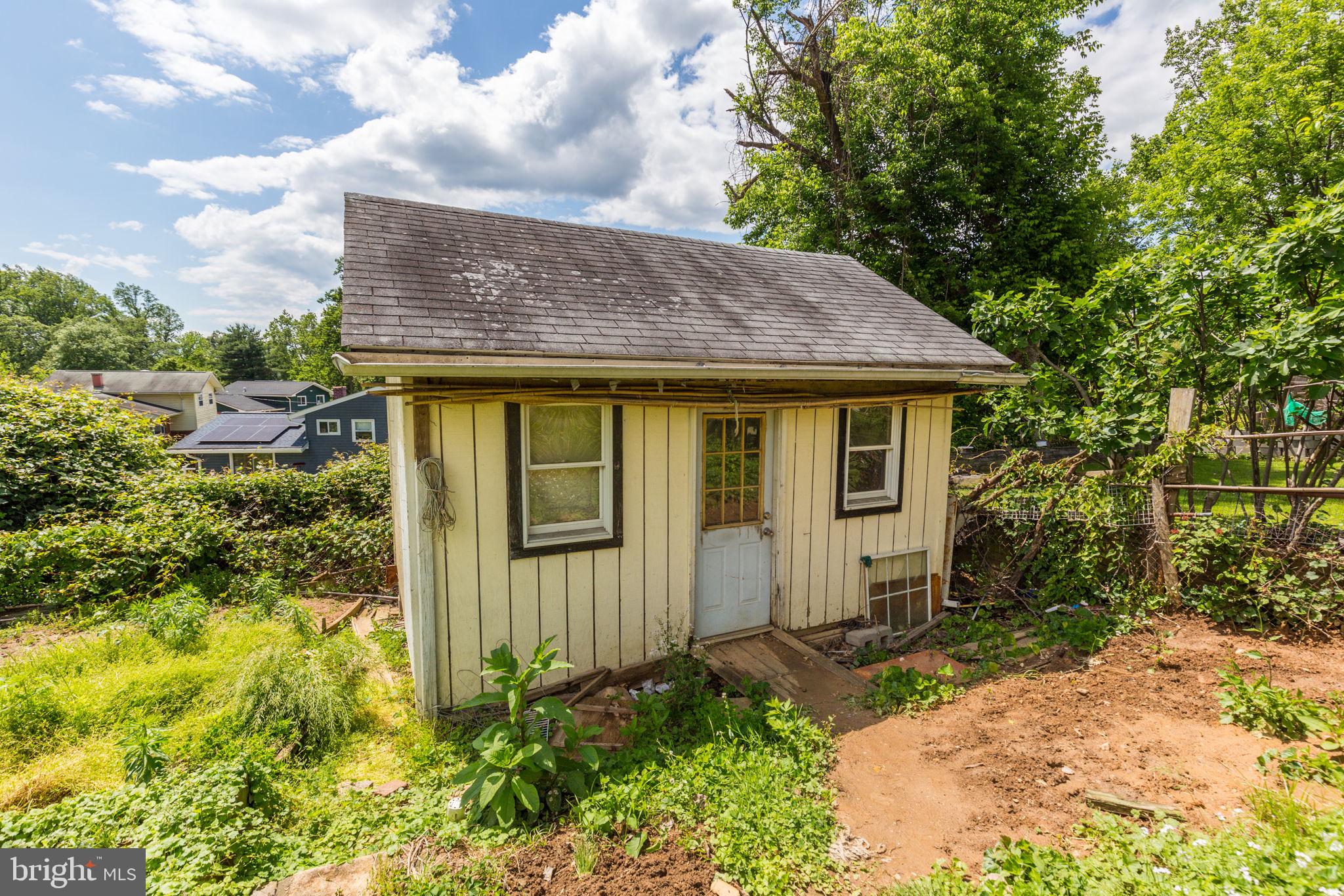 11830 Charles Road Silver Spring, MD 20906 - Photo 48 of 54 a view of a house with a small yard plants and large tree