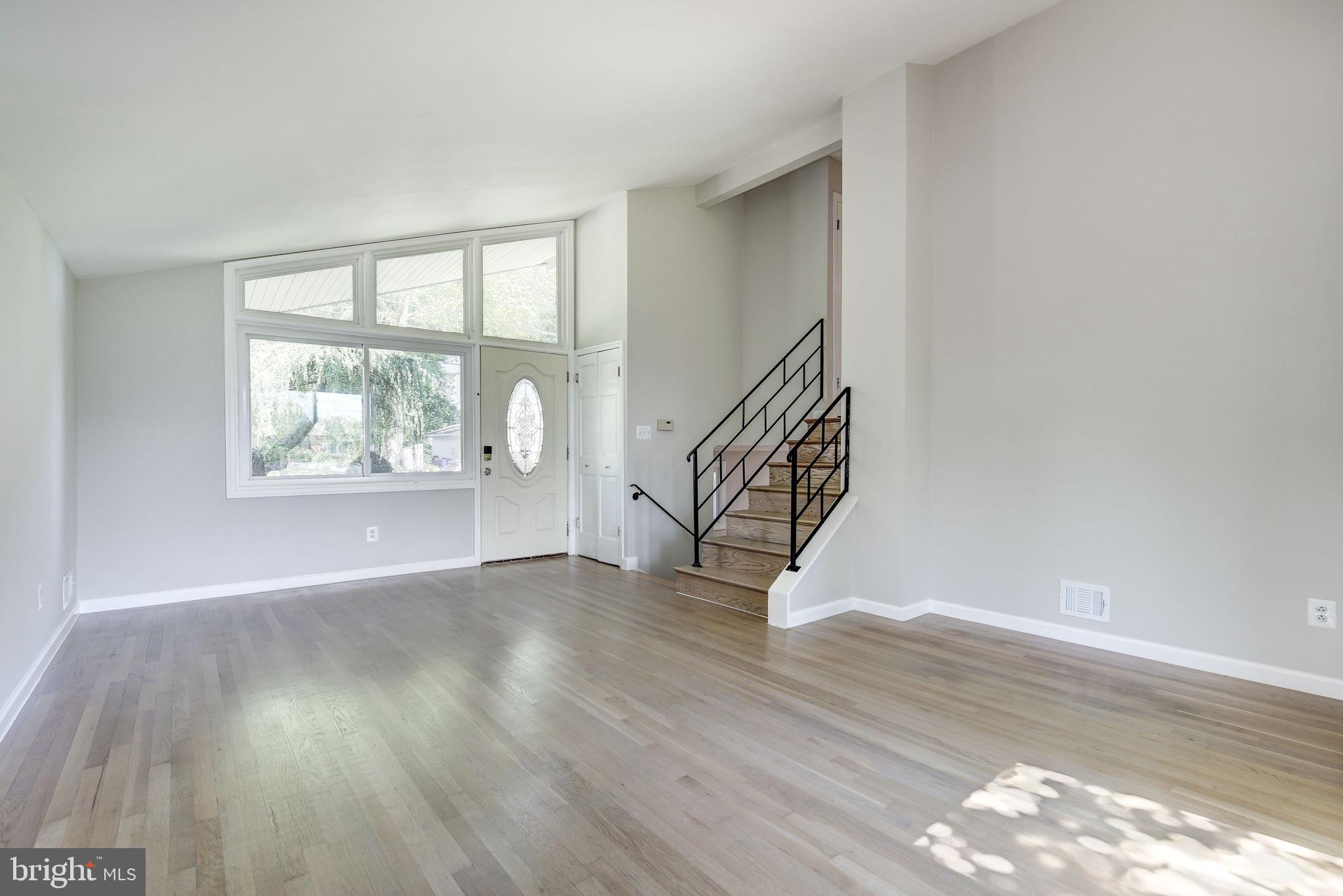 11830 Charles Road Silver Spring, MD 20906 - Photo 5 of 54 a view of an empty room with wooden floor and a window