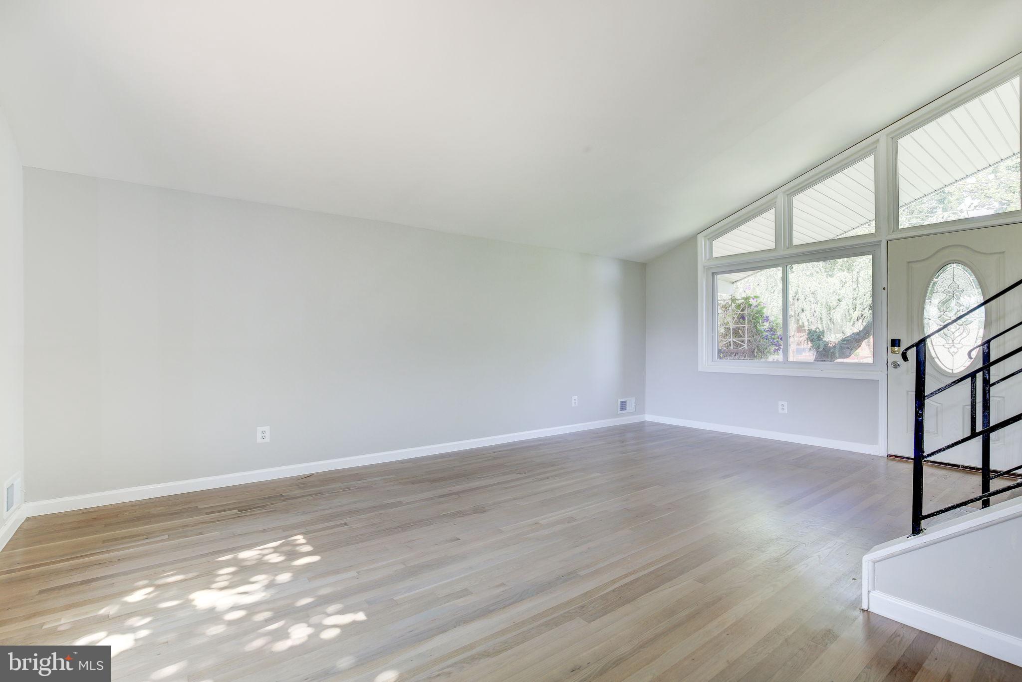 11830 Charles Road Silver Spring, MD 20906 - Photo 6 of 54 a view of an empty room with wooden floor and a window
