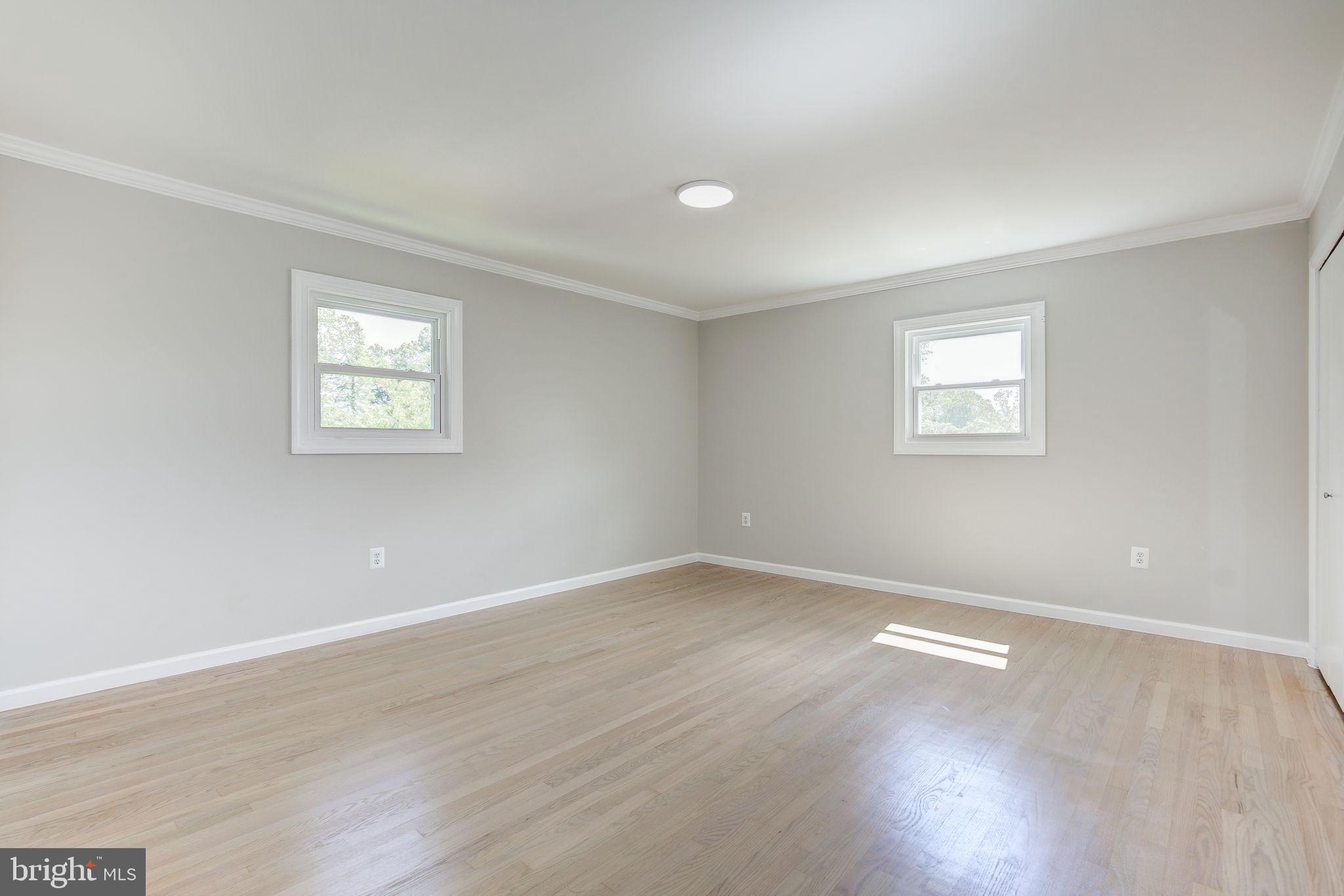 11830 Charles Road Silver Spring, MD 20906 - Photo 8 of 54 an empty room with wooden floor and windows