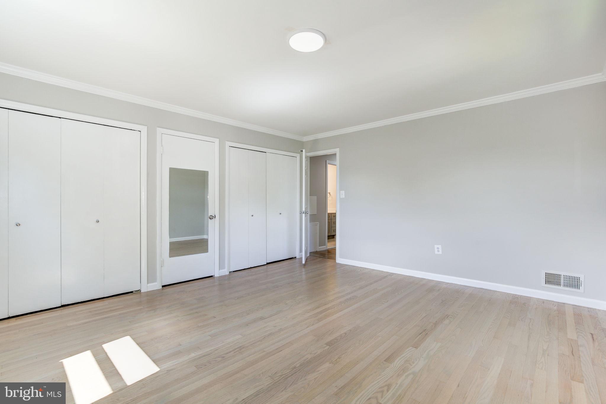 11830 Charles Road Silver Spring, MD 20906 - Photo 10 of 54 an empty room with wooden floor and windows