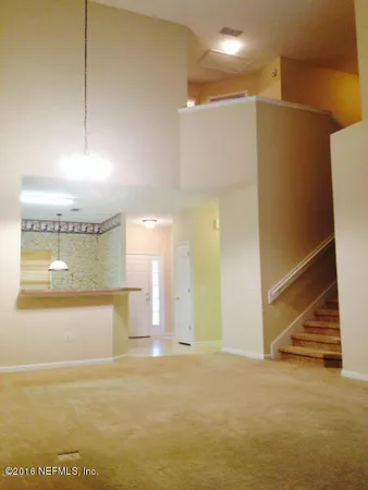 a view of a room with a kitchen