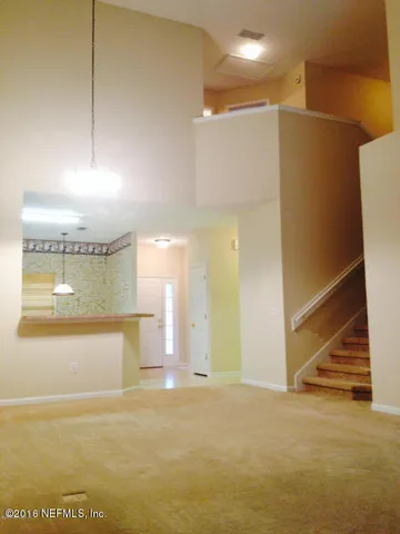 a view of a room with a kitchen