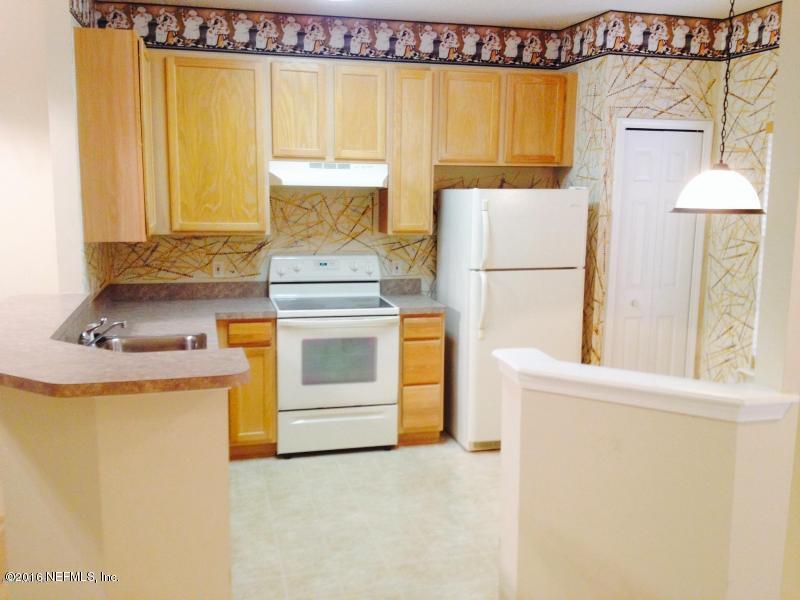1816 Cross Pines Drive Fleming Island, FL 32003 - Photo 13 of 13 a kitchen with a stove a sink and a refrigerator