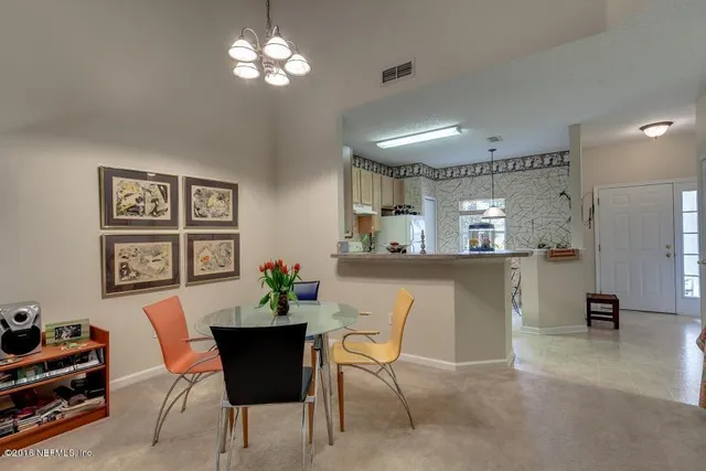 a view of a dining room with furniture and chandelier