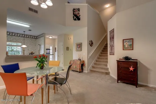 a view of a livingroom with furniture and a potted plant