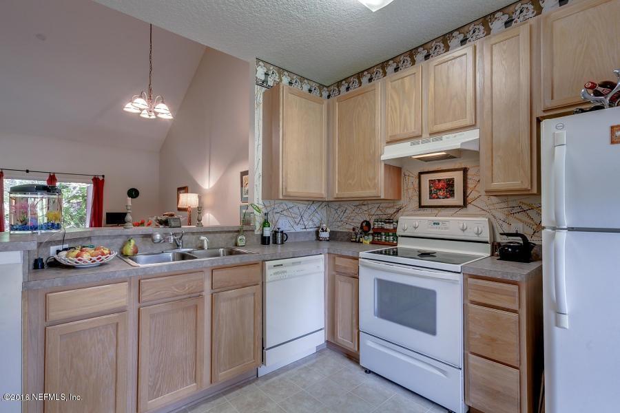1816 Cross Pines Drive Fleming Island, FL 32003 - Photo 6 of 13 a kitchen with white cabinets and white appliances