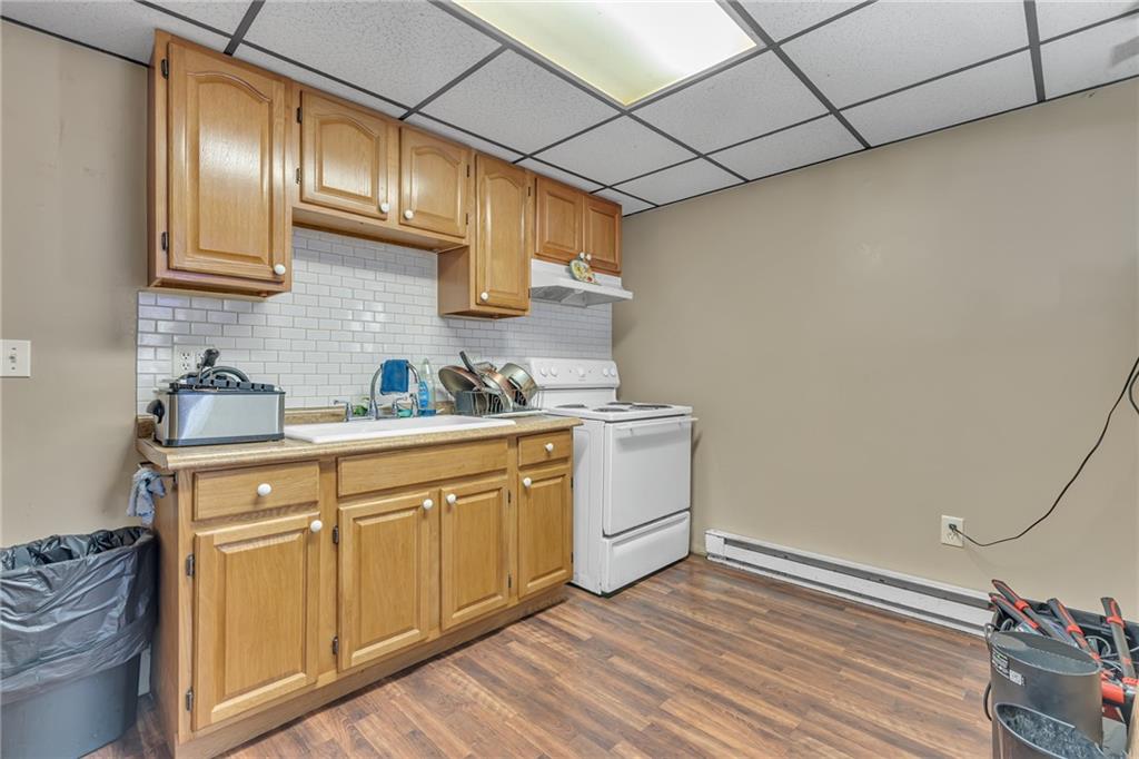 565 East Madison Street Rochester, PA 15074 - Photo 8 of 13 a kitchen with cabinets a sink and appliances