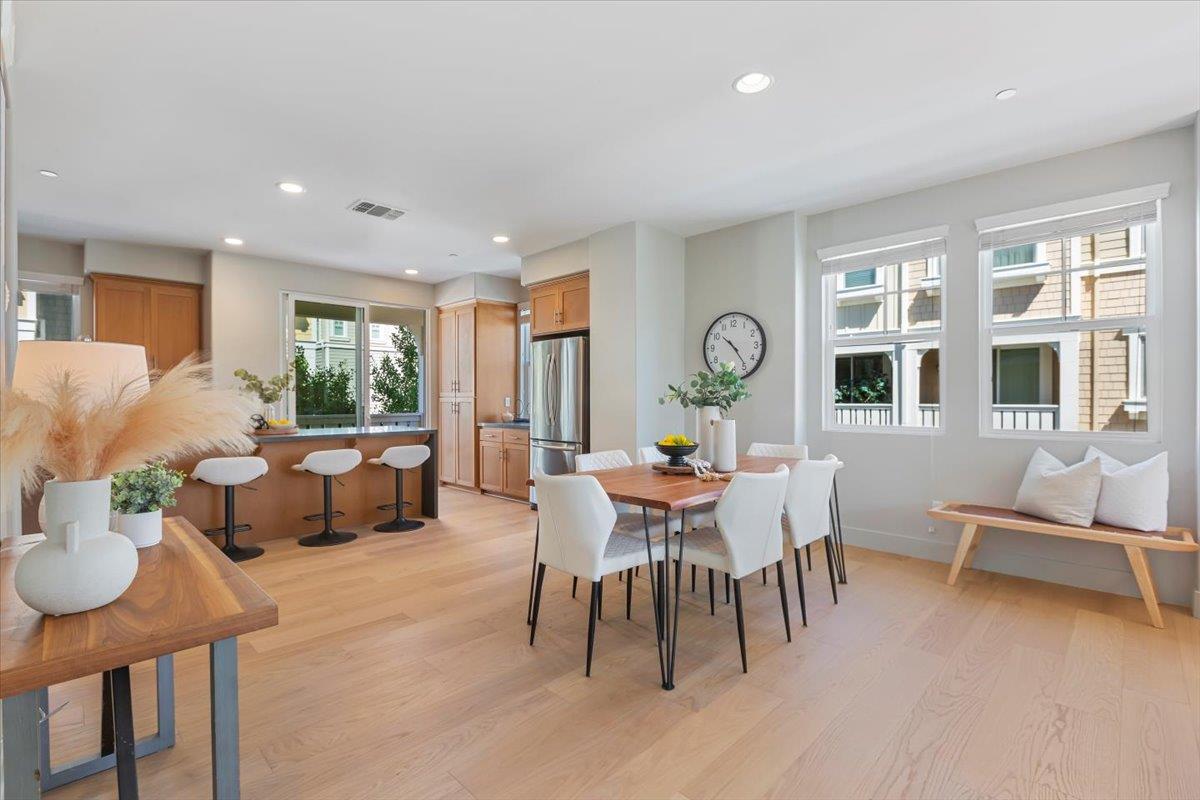 850 Sycamore Loop Mountain View, CA 94043 - Photo 12 of 36 a view of a dining room with furniture a large window and wooden floor
