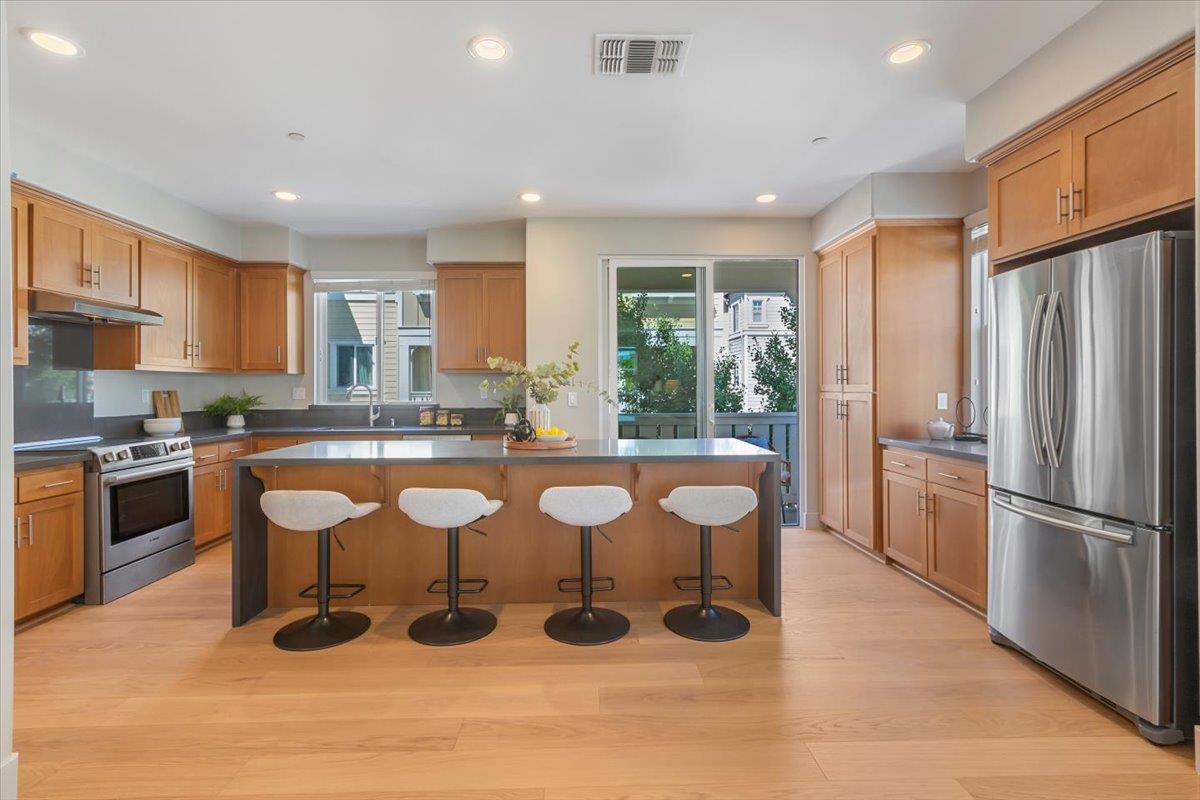 850 Sycamore Loop Mountain View, CA 94043 - Photo 14 of 36 a large kitchen with lots of counter space cabinetry and stainless steel appliances