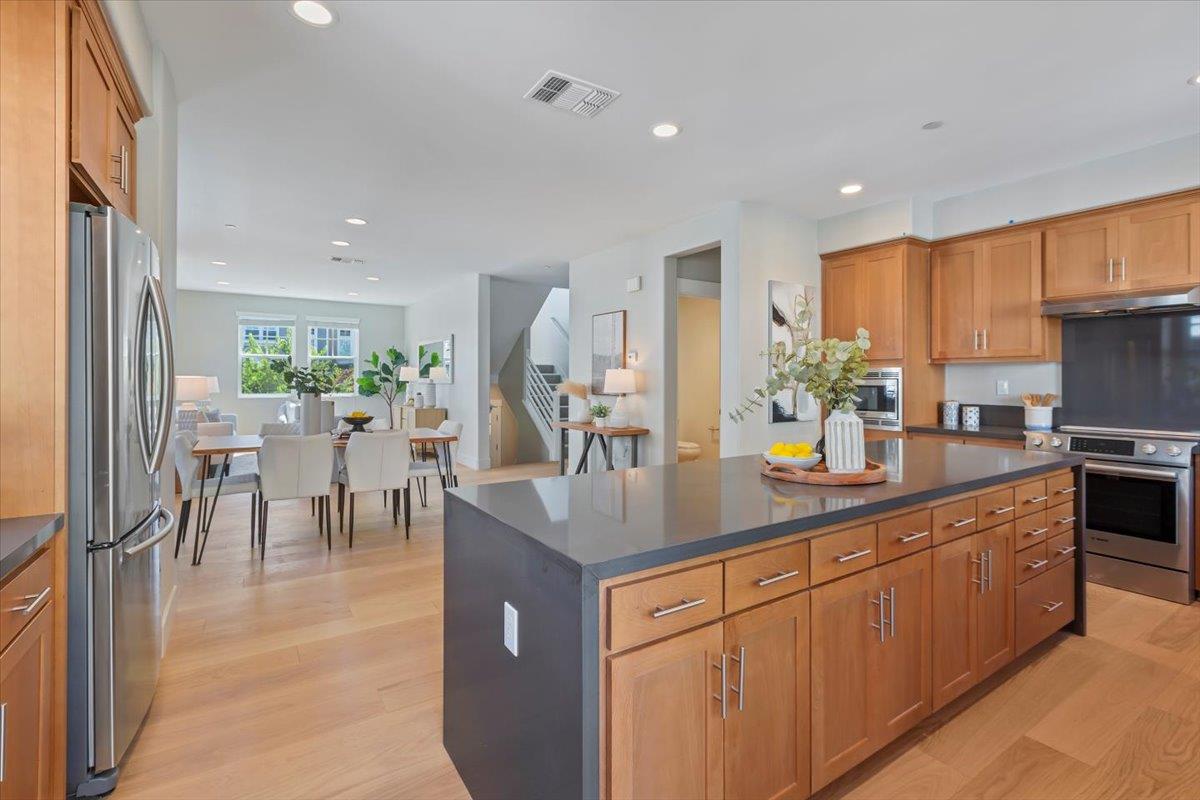 850 Sycamore Loop Mountain View, CA 94043 - Photo 15 of 36 a kitchen with counter top space sink and stainless steel appliances