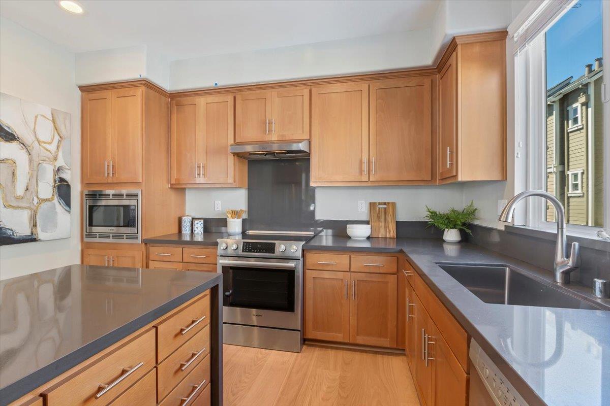 850 Sycamore Loop Mountain View, CA 94043 - Photo 17 of 36 a kitchen with stainless steel appliances granite countertop a sink stove and refrigerator