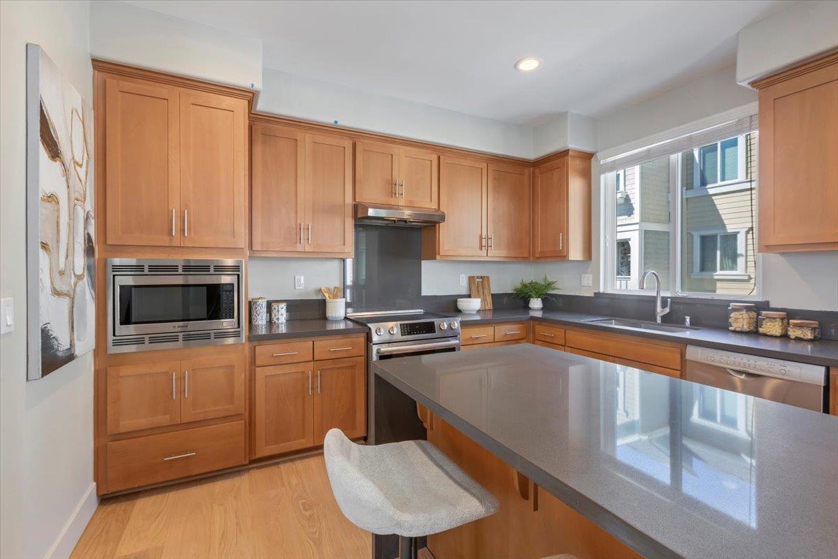 850 Sycamore Loop Mountain View, CA 94043 - Photo 18 of 36 a kitchen with stainless steel appliances granite countertop a stove a sink dishwasher and a refrigerator