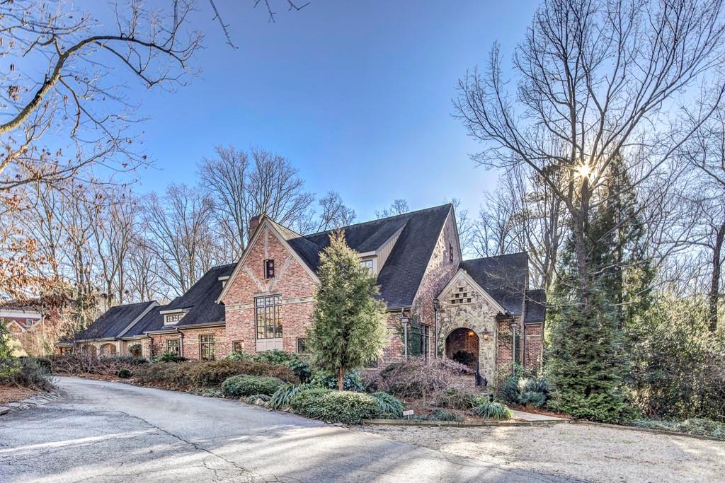 5745 Riverside Drive Sandy Springs, GA 30327 - Photo 1 of 1 a front view of a house with plants and trees