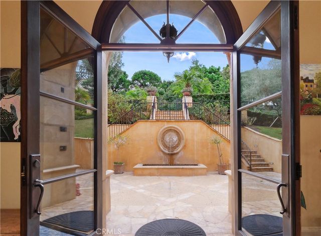 a dining room with furniture a chandelier and window